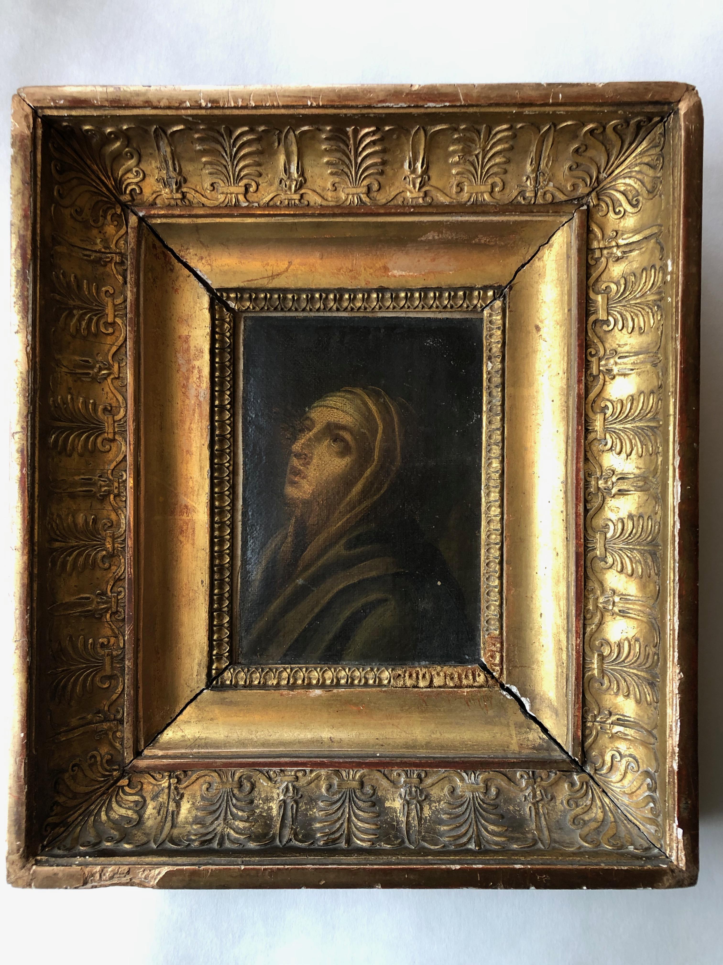 This is a magnificent 1700s oil on canvas painting of a praying woman, or Saint. It is beautifully painted in exquisite detail. The substantial carved wood gilded frame is equally amazing with its intricate and various scroll designs. The solid wood