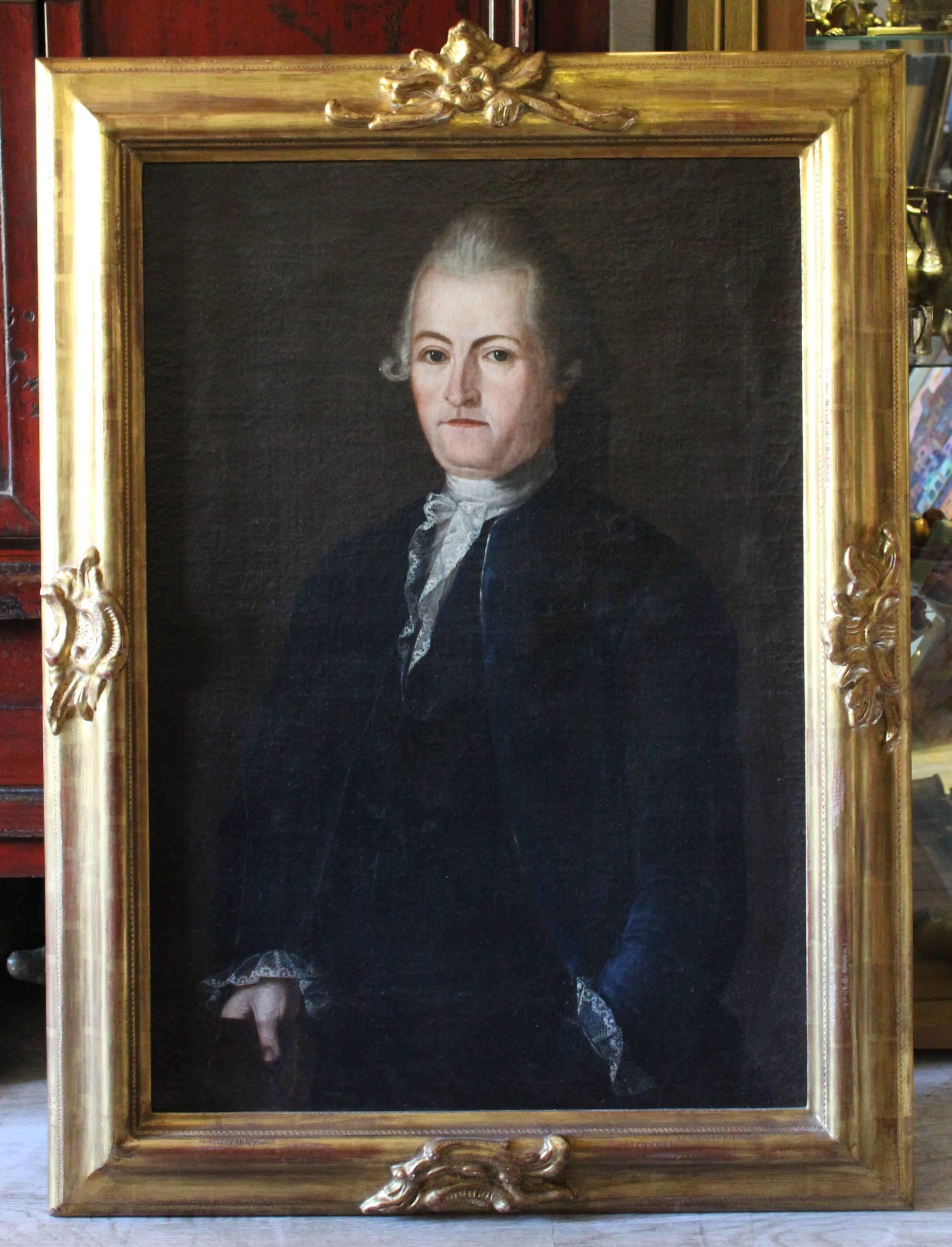 18th Century English style oil on canvas portrait of a gentleman in a black jacket holding a book. Period wooden gold gilded frame with late baroque 'rocaille' motifs. 

Canvas size: 91 x 61 cm.