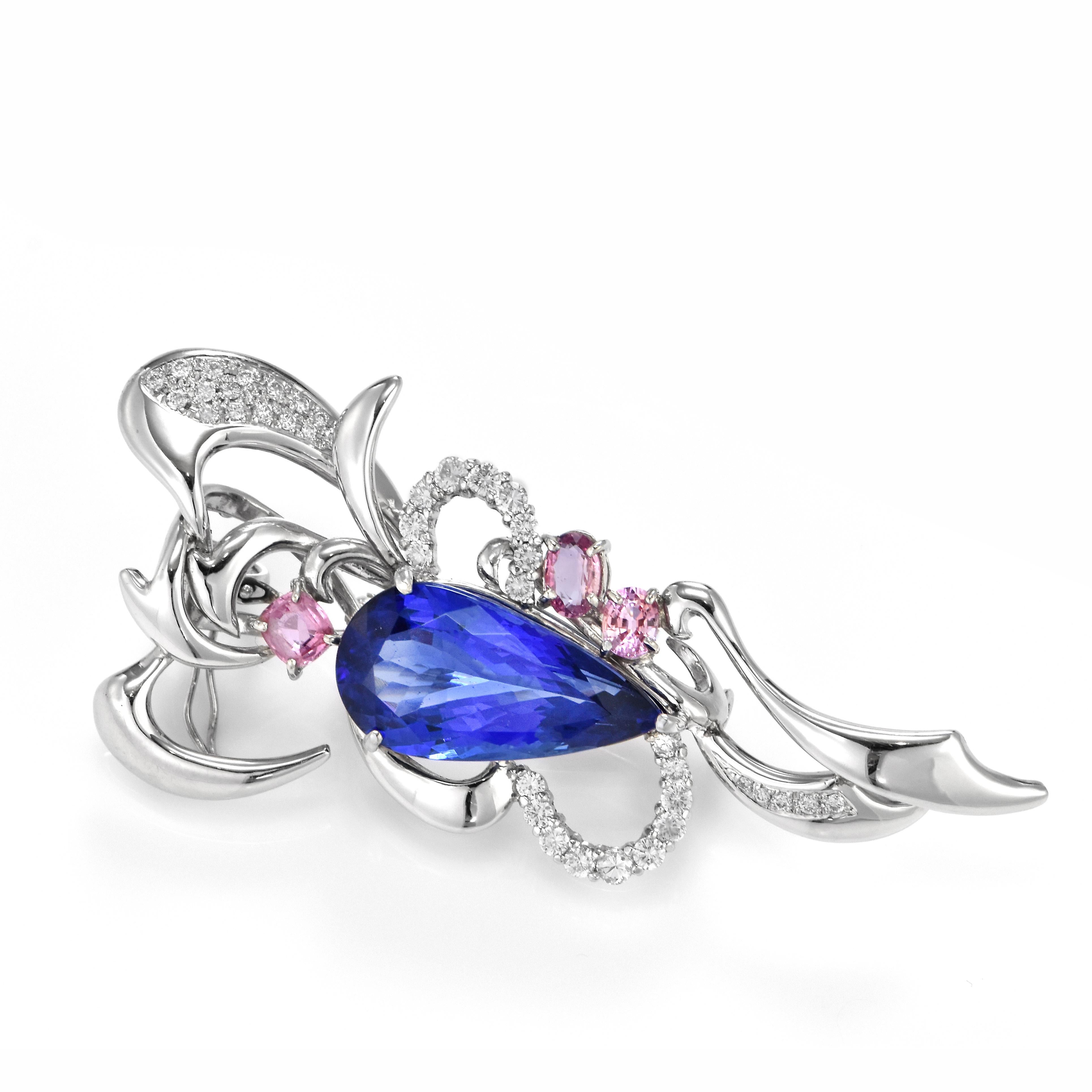 A beautiful brooch featuring a 17.06 Carat Natural Tanzanite, 1.662 Carat of Pink Sapphires and 1.09 Carat Diamonds Made in Platinum. Tanzanite's name was given by Tiffany and Co after its only known source: Tanzania. Tanzanite displays beautiful