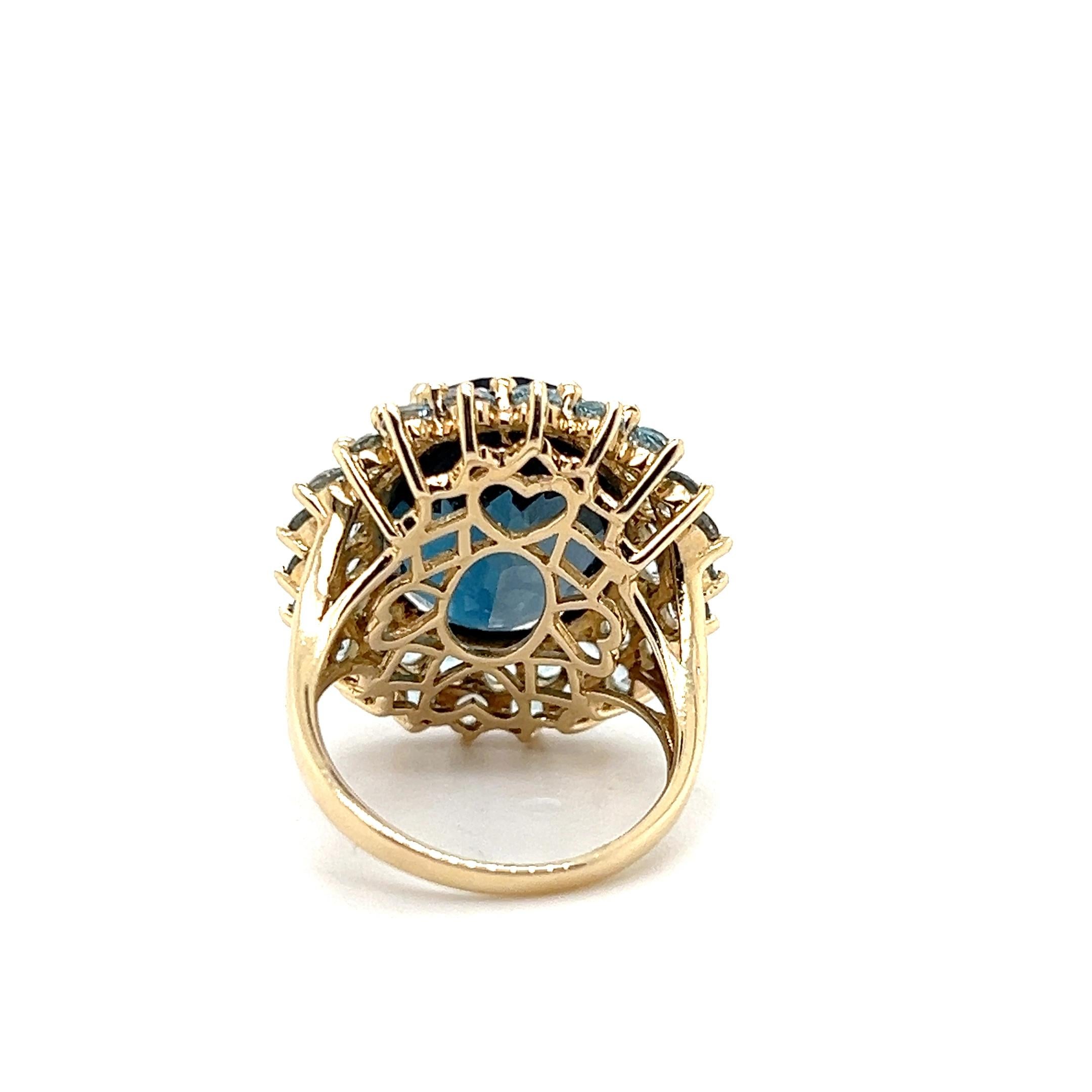 Oval Cut 17.07 Carat London Blue Checkerboard Cut Topaz and Yellow Gold Cocktail Ring For Sale
