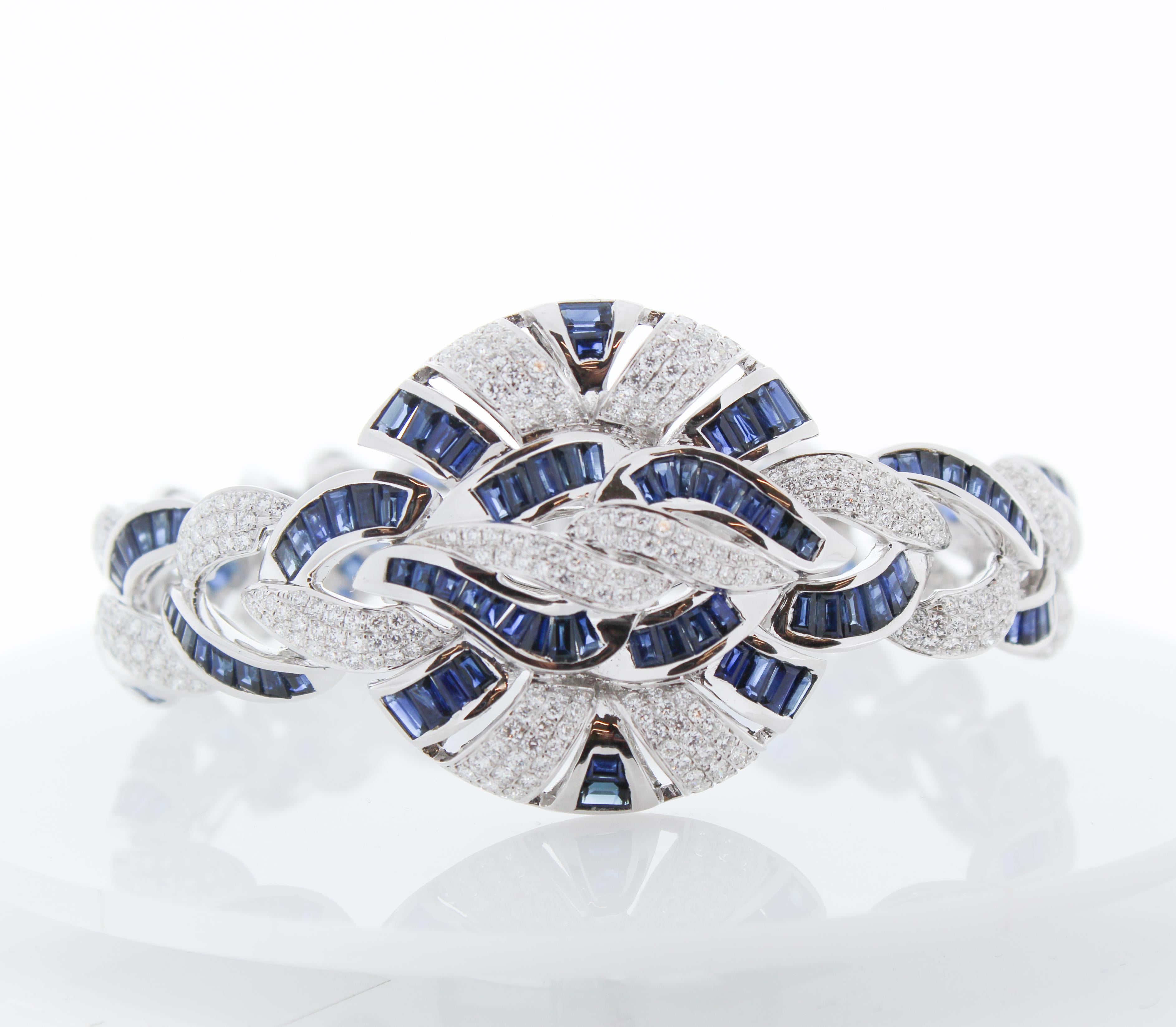 This decorative Art Deco style bracelet has 17 oval cut tanzanites totaling 21.67 carats. The gem source is near the foothills of Mt. Kilimanjaro in Tanzania; the suite is perfectly matched in size, vivid blue-violet, transparency, and luster. These