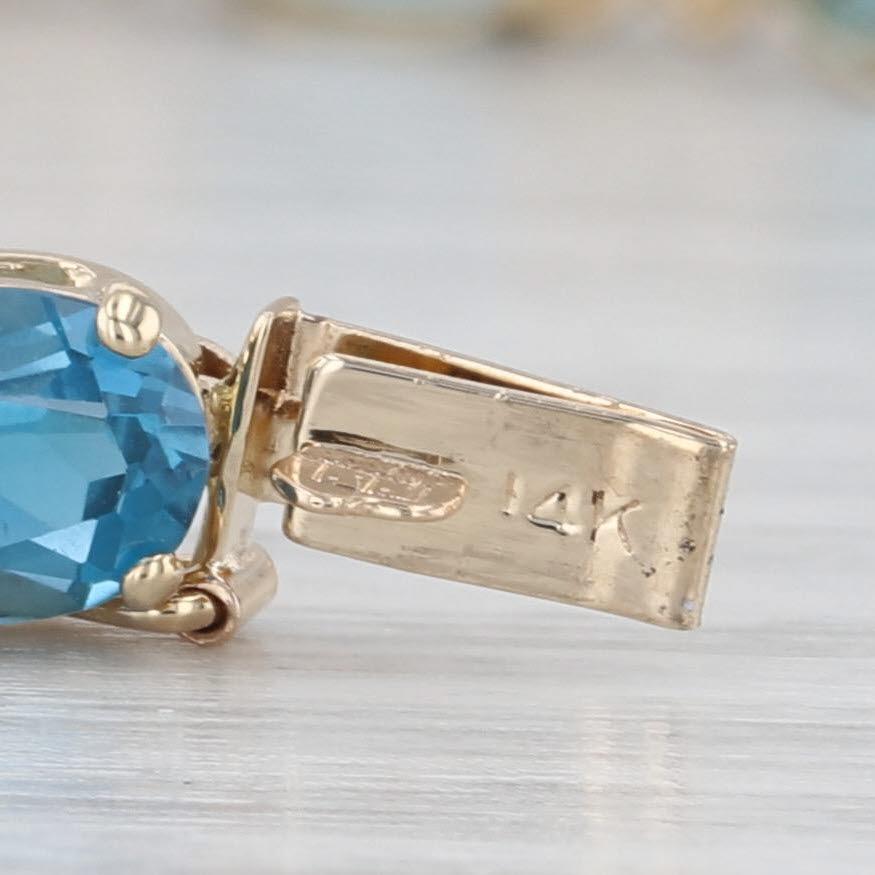 Taglio ovale Bracciale tennis con topazio blu di Londra da 17,09 ct. in oro giallo 14 ct. con accenti di diamanti da 7