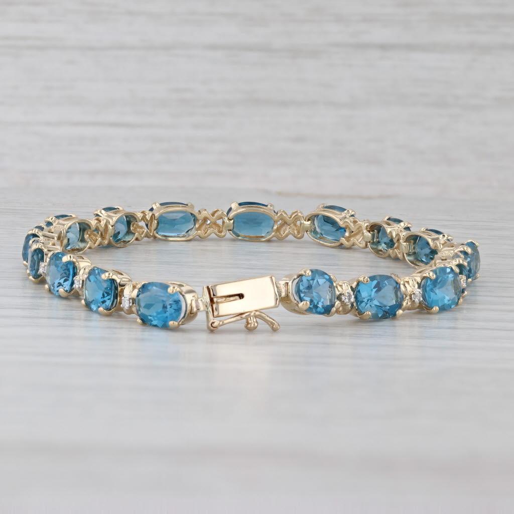 Bracciale tennis con topazio blu di Londra da 17,09 ct. in oro giallo 14 ct. con accenti di diamanti da 7