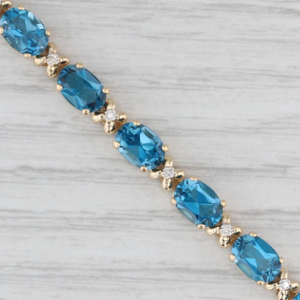 Bracciale tennis con topazio blu di Londra da 17,09 ct. in oro giallo 14 ct. con accenti di diamanti da 7
