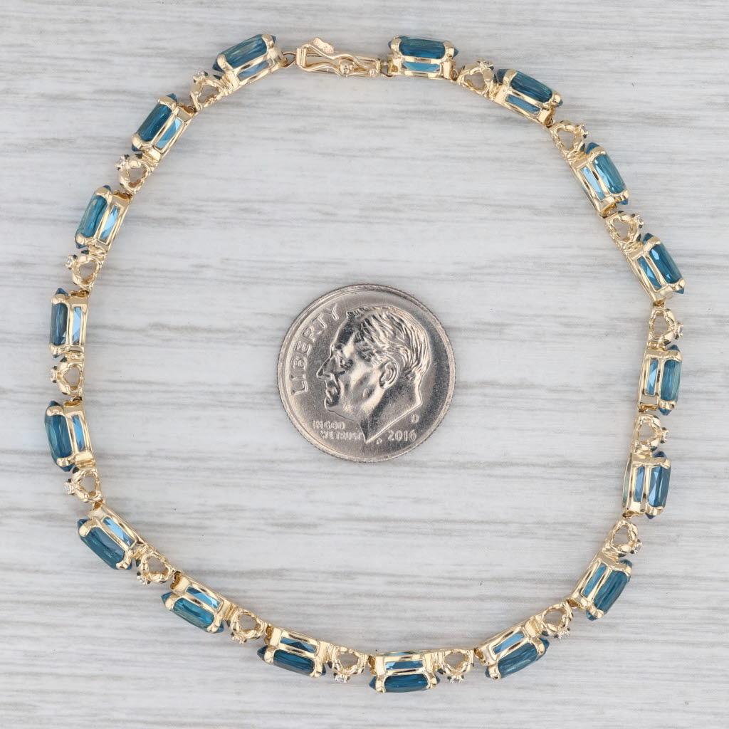 Bracciale tennis con topazio blu di Londra da 17,09 ct. in oro giallo 14 ct. con accenti di diamanti da 7