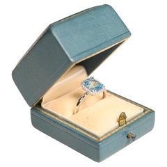 Bague de fiançailles en or blanc 18 carats avec topaze bleue (environ 1,7 carat), halo de diamants