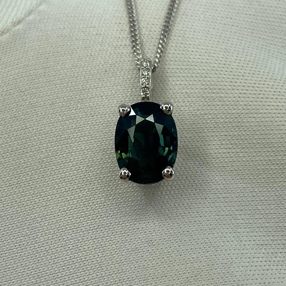 Deep Green Blue Sapphire Oval Cut 18k White Gold Diamond Surround-Set Pendant Necklace.

1.70 Carat sapphire with a fine deep green blue colour and excellent clarity. Very clean stone. Also has an excellent oval cut which displays the fine colour to