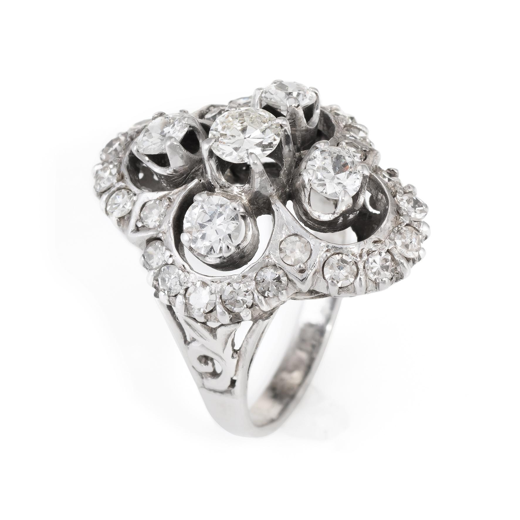 Finely detailed vintage cocktail ring (circa 1950s to 1960s), crafted in 14 karat white gold. 

4-prong set round brilliant cut diamonds, measuring 4.41 - 4.38 - 2.45mm (depth est) approximate weight 0.30ct. Graded in setting. Clarity SI-1. Color: