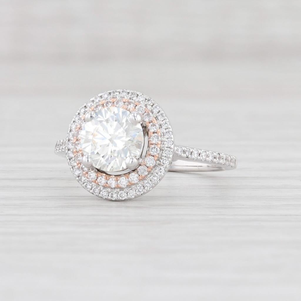 This gorgeous diamond halo ring has a 1.30 Carat round center framed by two halos of sparkling genuine diamonds. The inner frame is done in rose gold creating a lovely pop of color among  the white gold. The center diamond has a XXX rating with