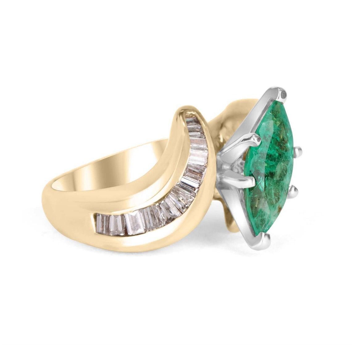Displayed is a stunning emerald marquise and diamond ring. The center gemstone is an emerald marquise handset in a six-prong setting that allows for a full view of the emerald. Baguette diamonds are channel set on the shank of the ring and cover the