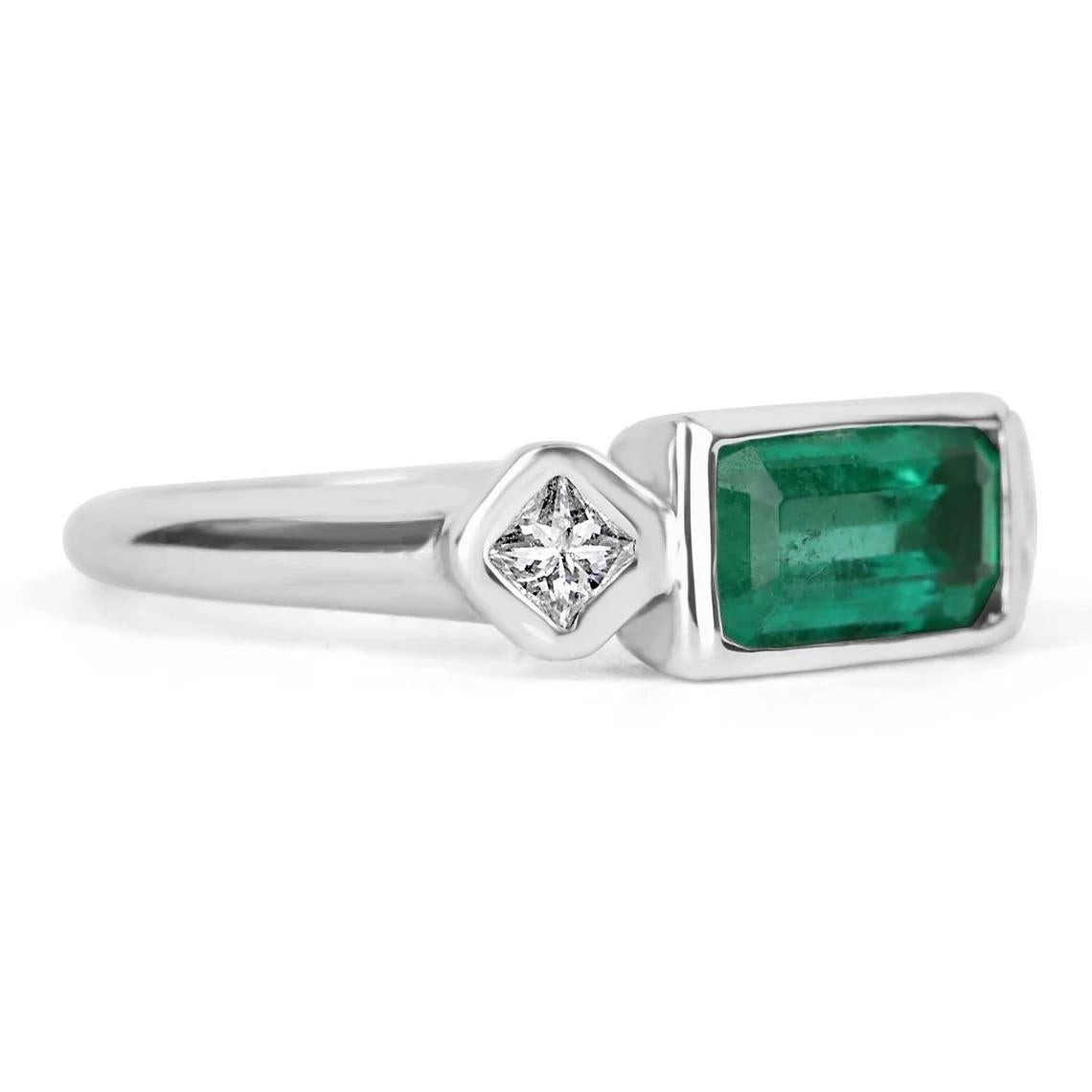 A Colombian emerald and princess cut three stone ring. Dexterously handcrafted in gleaming 18K white gold, this ring features a 1.40-carat natural elongated emerald, emerald cut from the famous Muzo mines. Set in a secure bezel setting for extra