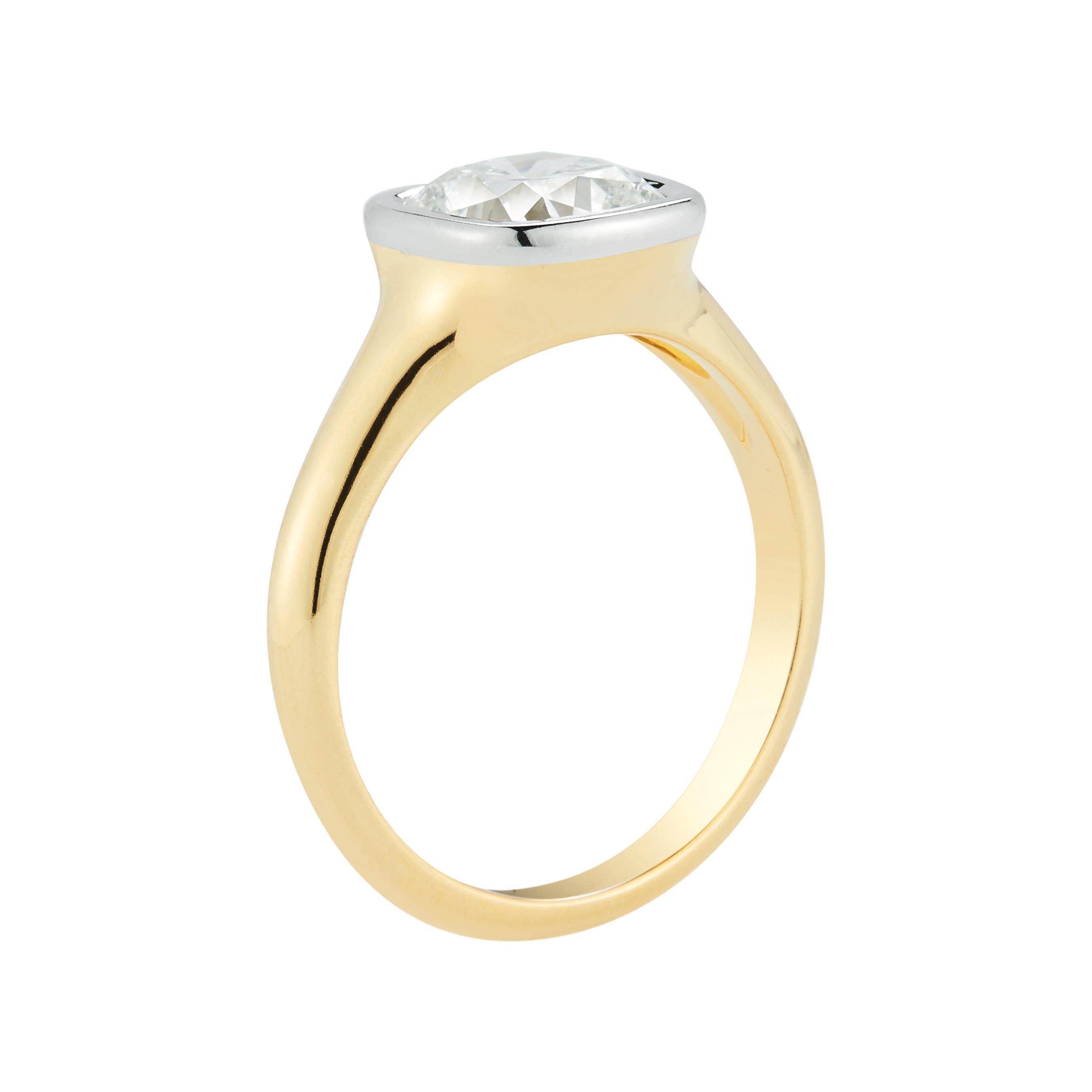 When you start with a spectacular diamond, the rest of the ring falls into place. This beautiful 1.71 ct cushion cut diamond is framed with a delicate platinum bezel to accentuate the stone's natural sparkle. The yellow gold band adds the perfect