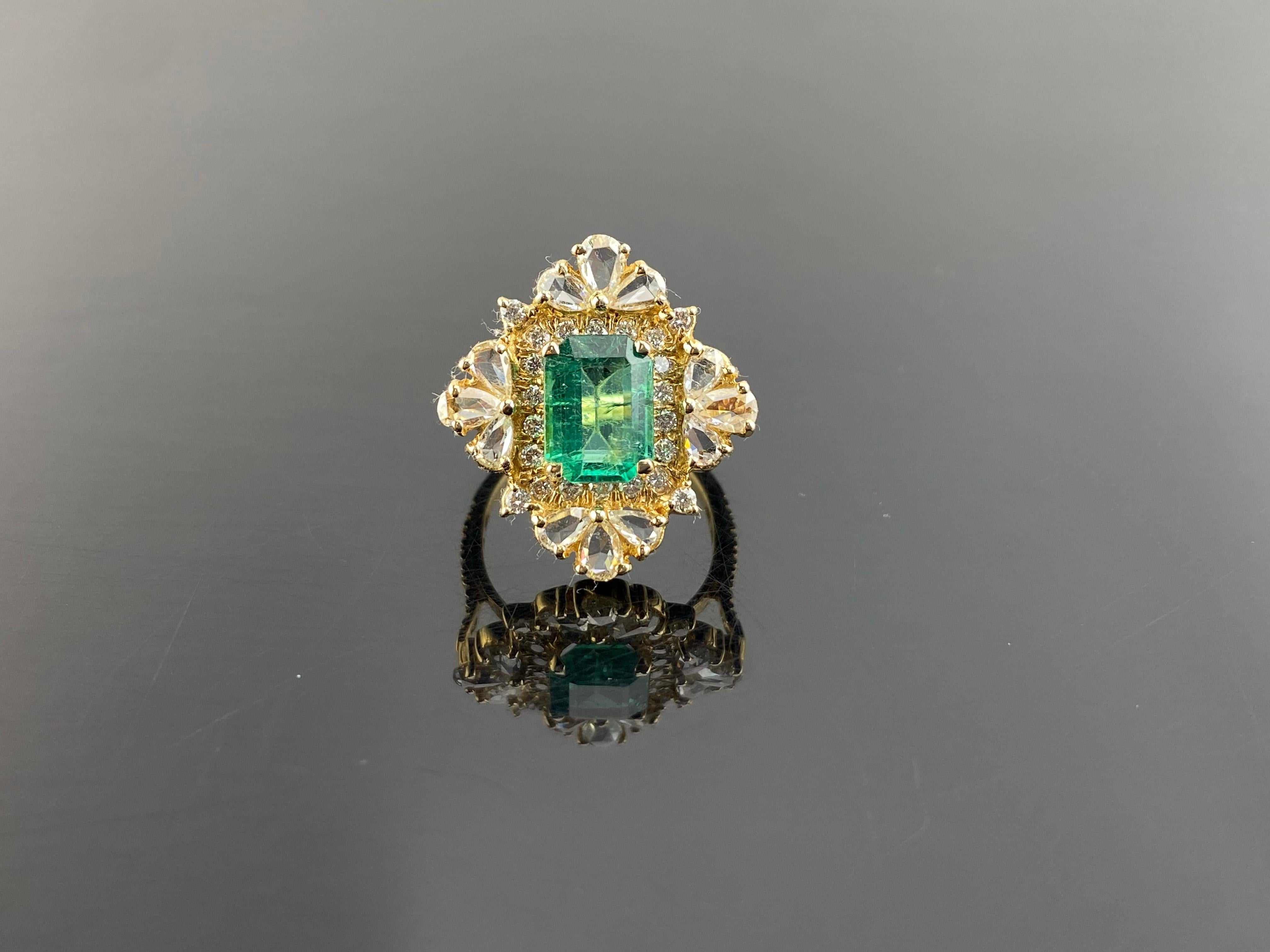 A beautiful, antique-looking 1.71 carat Zambian Emerald and 1.45 carat rose cut and full cut White Diamond cocktail ring, all set in solid 18K Yellow Gold. The ring is currently sized at US 6.5, can be resized. The center stone Emerald is