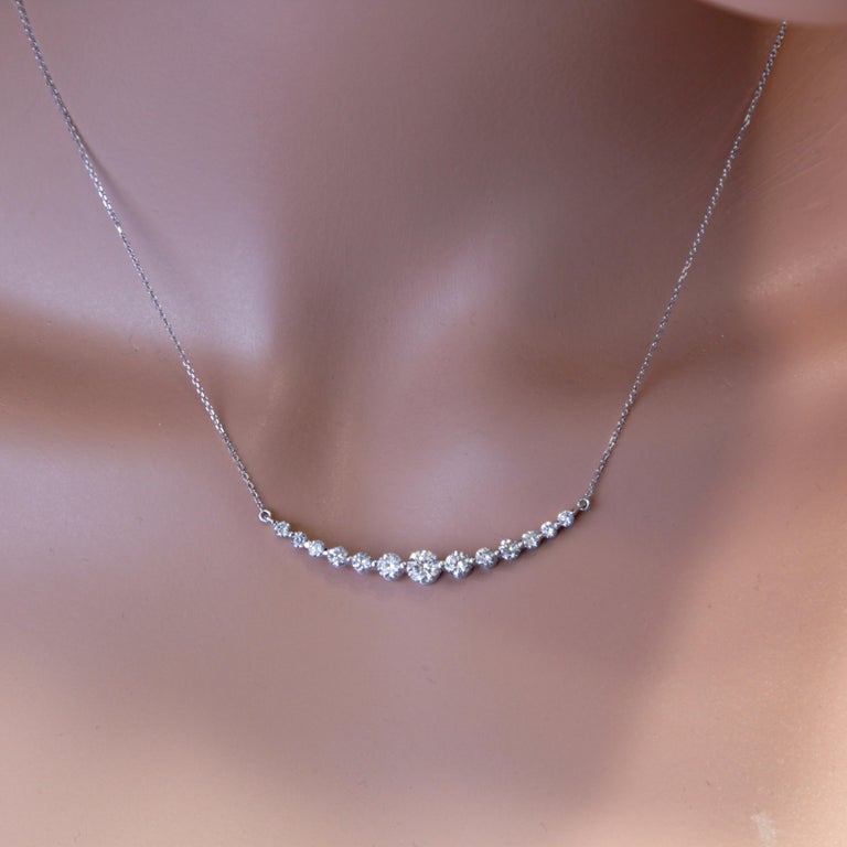 This diamond necklace with attached chain has fifteen round diamonds in graduated size, totaling 1.71 carats. A raised under gallery completes the piece. Set in 14k White Gold.
Suggested retail price $12,700

Diamond Town is proud to offer a wide