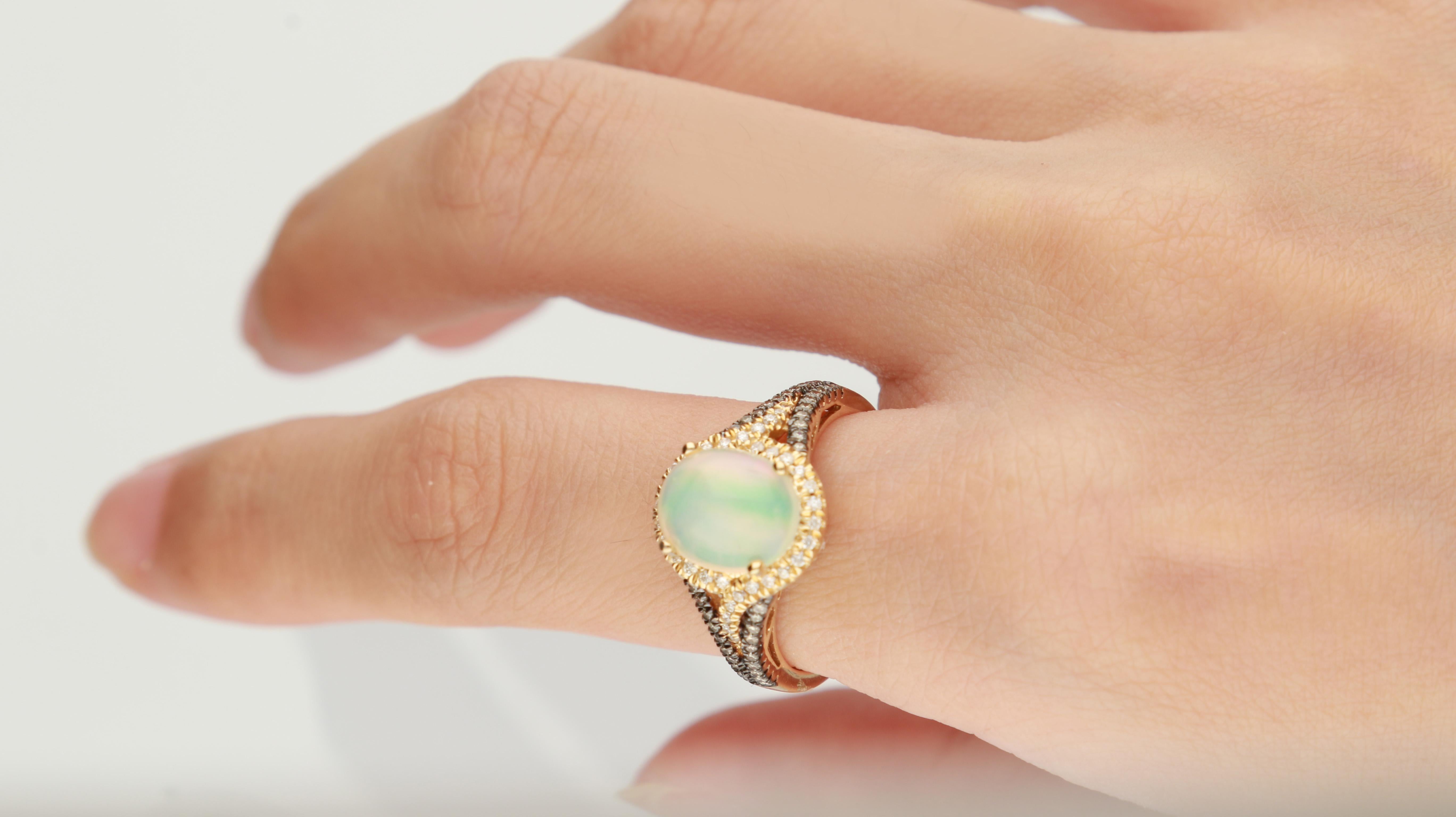 This beautiful Opal ring is crafted in 14-karat Yellow gold and features a 1.71 carat Natural Ethiopian Opal, 34 Round White Diamonds in GH- I1 quality with 0.14 ct and 40 Round Brown Diamond 0.15 Carat, in a prong-setting. This ring comes in sizes