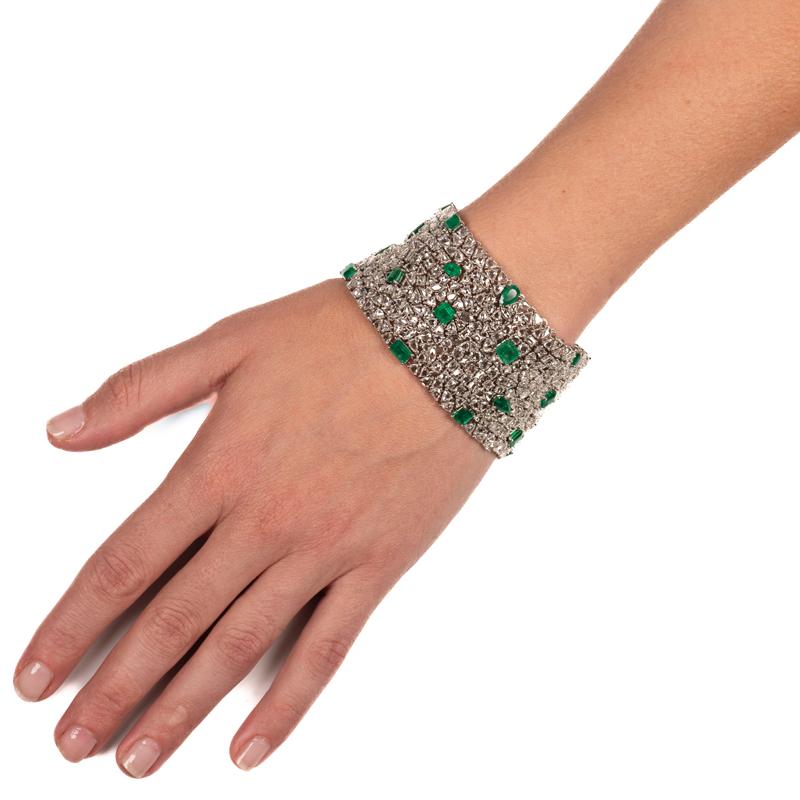 This beautiful and one of a kind bracelet features 34 multi cut emeralds totaling 17.10 carats and 40 carat total weight in rose cut diamonds set in 18 karat white gold. It is definitely a unique show stopper! 