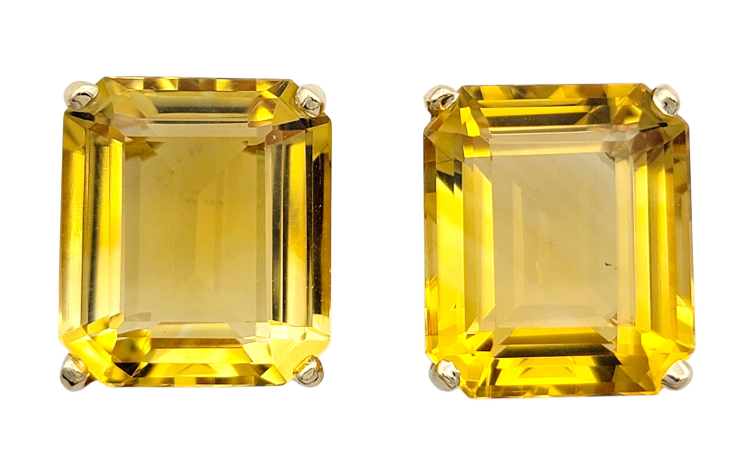 These bold citrine stud earrings radiate a warm, golden brilliance that instantly captures attention. Each earring features a striking emerald-cut citrine with crisp, mirror-like facets that reflect shades of amber and honey under the light. Their