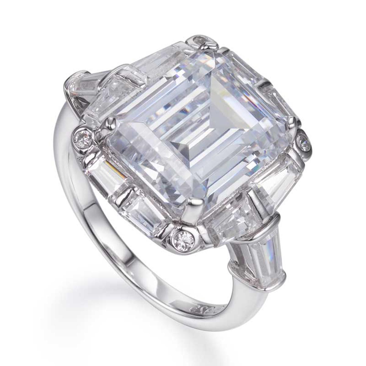 Part of our Deco Collection, and inspired by the roaring twenties, this beautiful ring epitomises such an iconic decade. 

This majestic statement ring exudes glamour and sophistication. A large 17.16ct centre emerald cut cubic zirconia is flanked