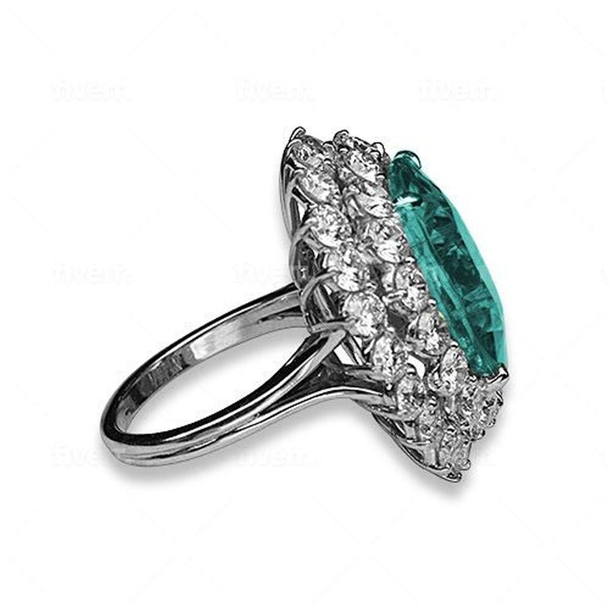 Simply Beautiful! Finely detailed Paraiba Tourmaline and Diamond Platinum Ring. Center securely nestled with an Oval Neon Blue/Green GIA Paraiba Tourmaline SI, weighing approx. 17.16 Carats surrounded by Diamonds, E/F, VS, weighing approx.6.21tcw.