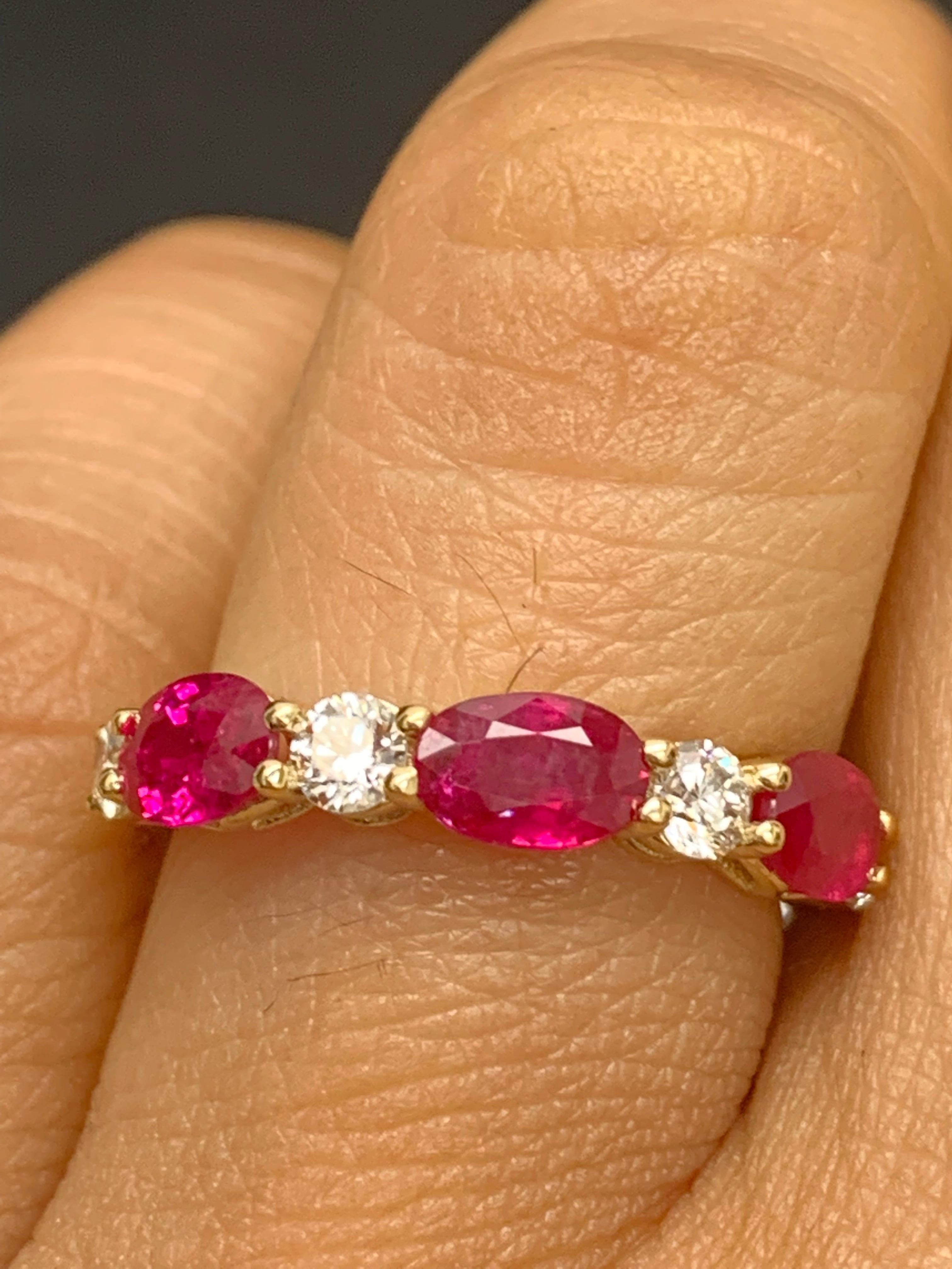Handcrafted to perfection; showcasing color-rich oval cut rubies that elegantly alternate round diamonds in a 14k Yellow  gold setting. 
The 3 rubies weigh 1.71 carats total and 4 diamonds weigh 0.61 carats total.

Size 6.5 US (Sizable). One of a