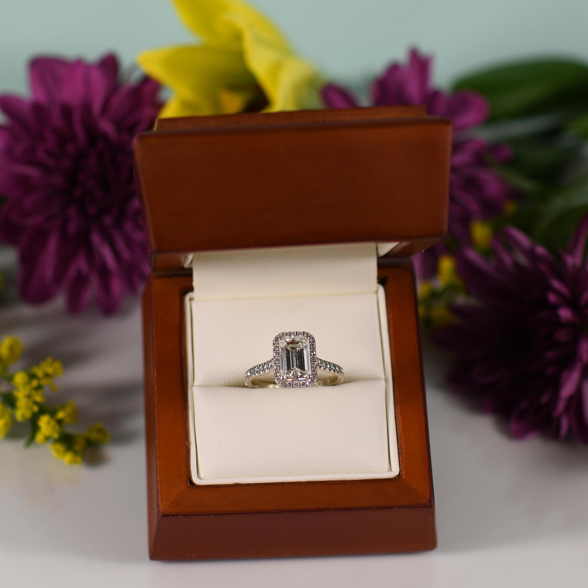 Elevate your style with this contemporary masterpiece featuring a stunning 1.71 carat emerald cut diamond elegantly framed by a sparkling diamond halo. Set in luxurious 14k white gold, the sleek and modern design of the ring accentuates the timeless