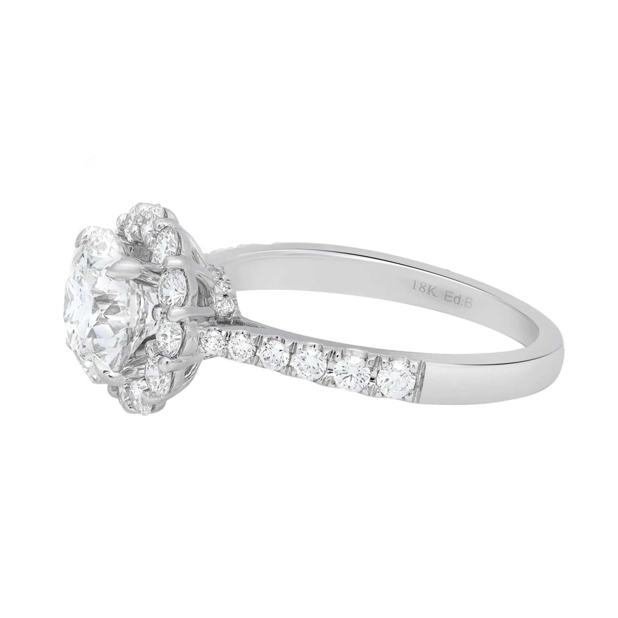 This enchanting ring is adorned with a sparkling GIA certified round brilliant cut diamond in the center, secured firmly in a beautiful four prong setting and a classic round cut diamond shank that lends the final touch to the design aesthetic. The