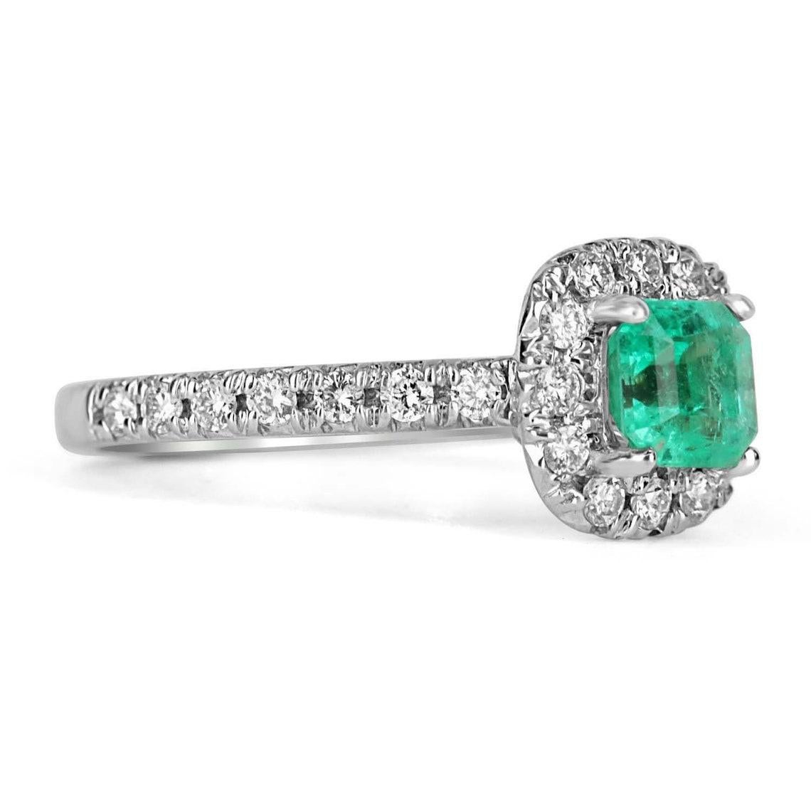 This is an exquisite, Colombian emerald and diamond halo ring. The gorgeous setting lets sit an excellent quality Colombian emerald with beautiful color and very good eye clarity. The emerald is not perfect and small imperfections do exist as it is