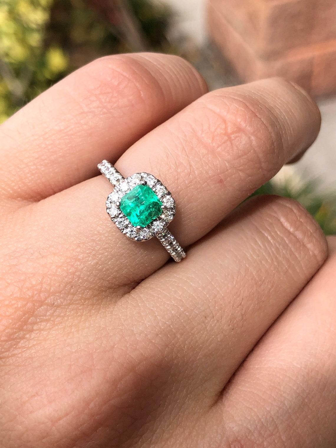 diamond ring with emerald accents