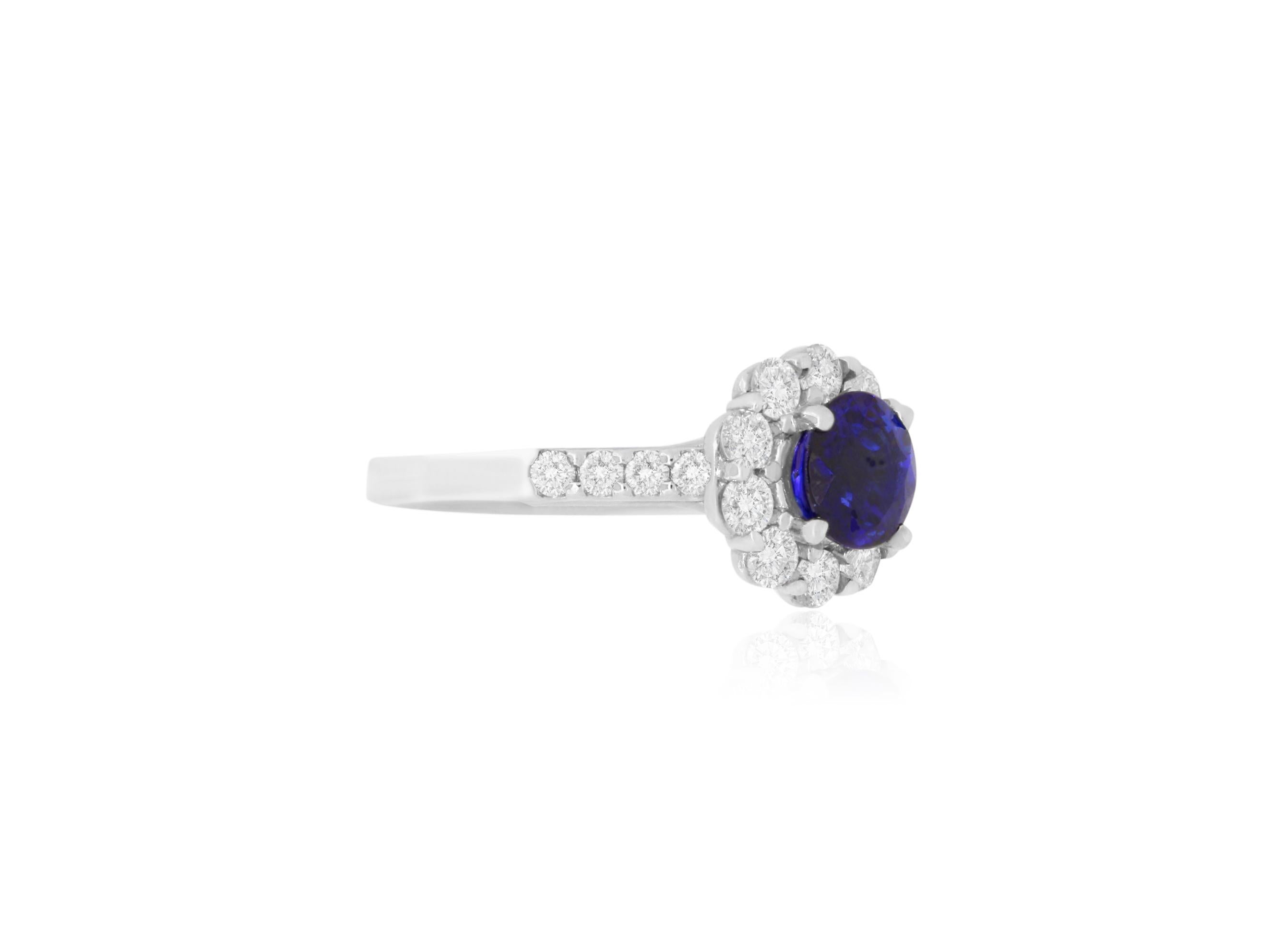Material: 18k White Gold 
Center Stone Details:  1.72 Carat Round Blue Sapphire
Mounting Diamond Details: 18 Round White Diamonds Approximately 0.93 Carats - Clarity: SI / Color: H-I
Ring Size: Size 6.5 (can be sized)

Fine one-of-a kind