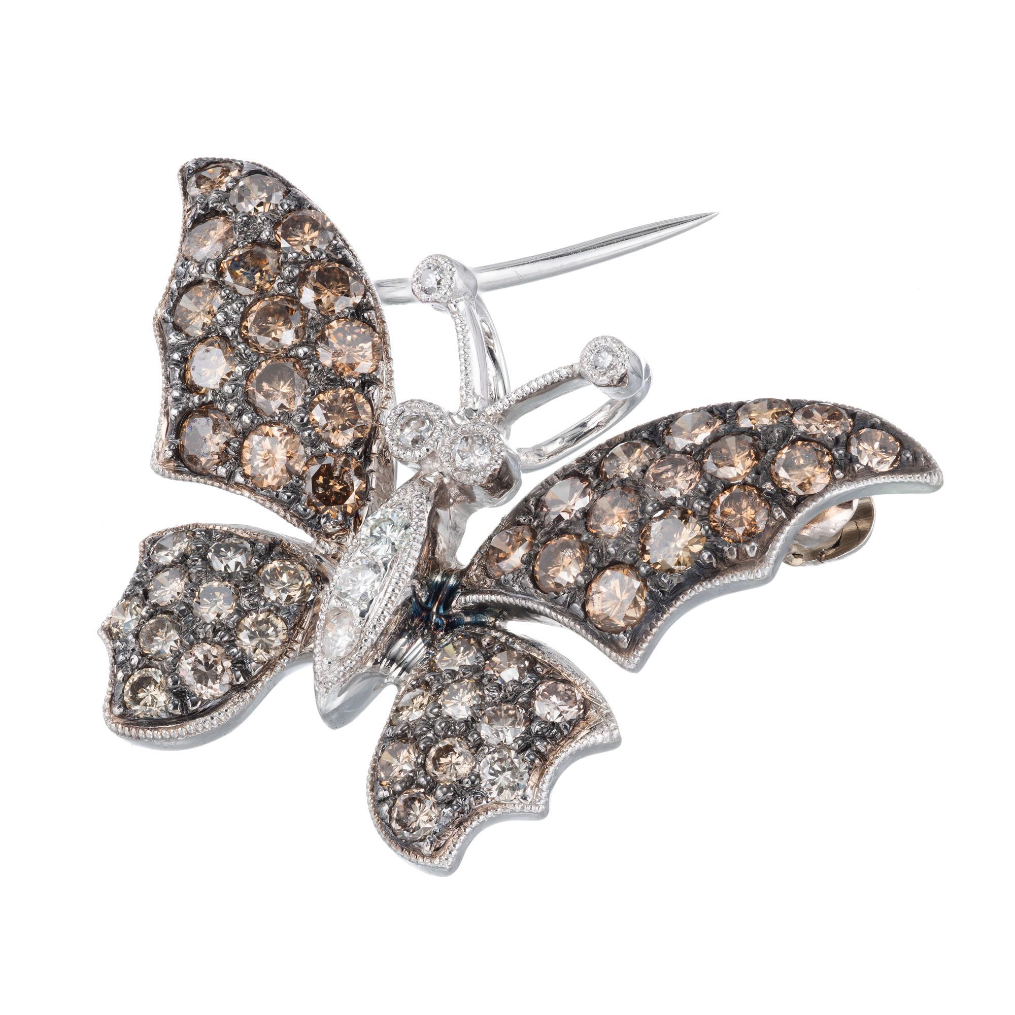 Brown and white diamond Butterfly brooch pendant. Golden brown diamond wings with a white diamond body in 18k white gold. 

7 round white diamonds, approx. total weight .08cts
50 round natural golden brown diamonds, approx. total weight 1.64cts, VS