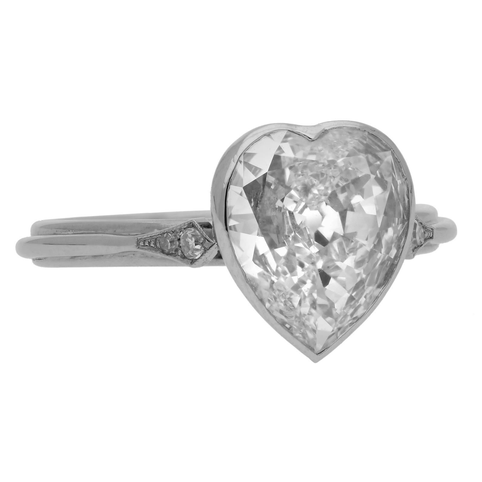 A beautiful rare and romantic heart old mine diamond solitaire ring by Hancocks, set with a heart-shaped old-cut diamond weighing 1.72cts and of H colour and VS2 clarity in a hand-made platinum bezel setting with pierced gallery and with single cut
