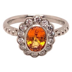 1.72 Carat Oval Cut Orange Sapphire and Diamond Cluster Ring in 18k White Gold