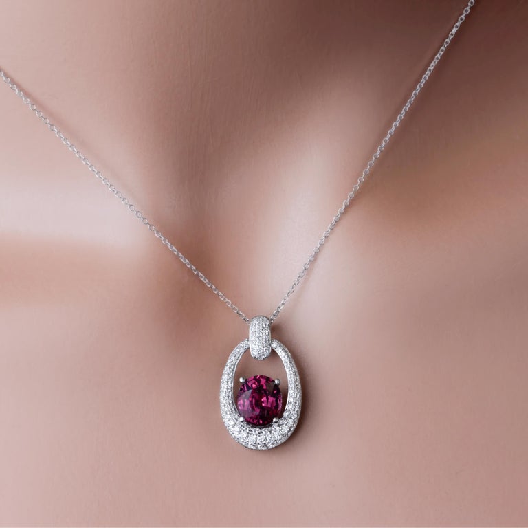 This pendant has a 1.72 carat exotic garnet set inside a frame of round white diamonds. Additional diamonds on the bail bring the total diamond weight to 0.68 carats. Set in 18k White Gold
Suggested retail price $6,947

DiamondTown is pleased to