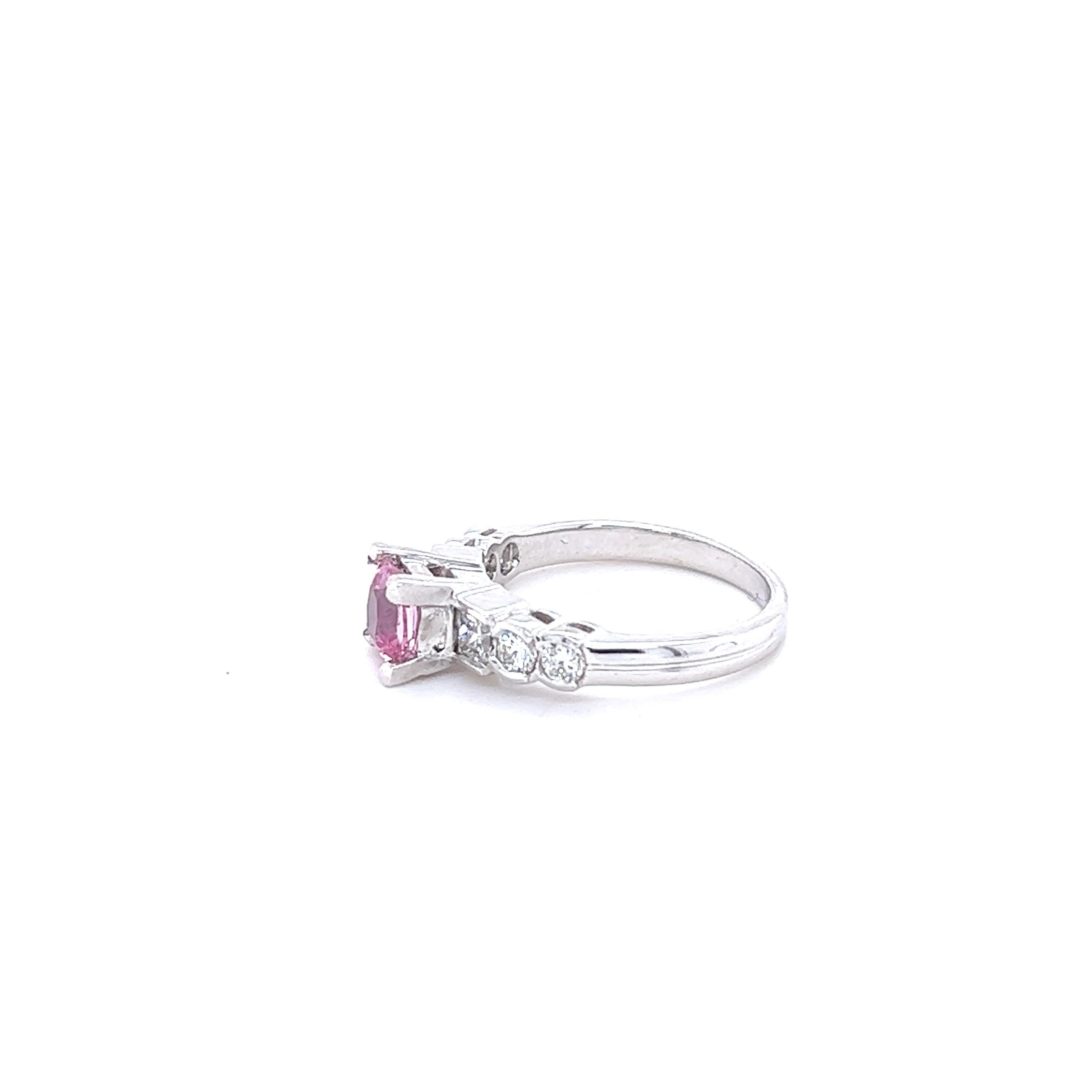 This beautiful ring has a Natural Cushion Cut Pink Sapphire that weighs 1.02 Carats and measures at approximately 5 mm x 5 mm. 

The ring is embellished with 4 Round Cut Diamonds and 2 Princess Cut Diamonds that weigh 0.70 Carats with a clarity and