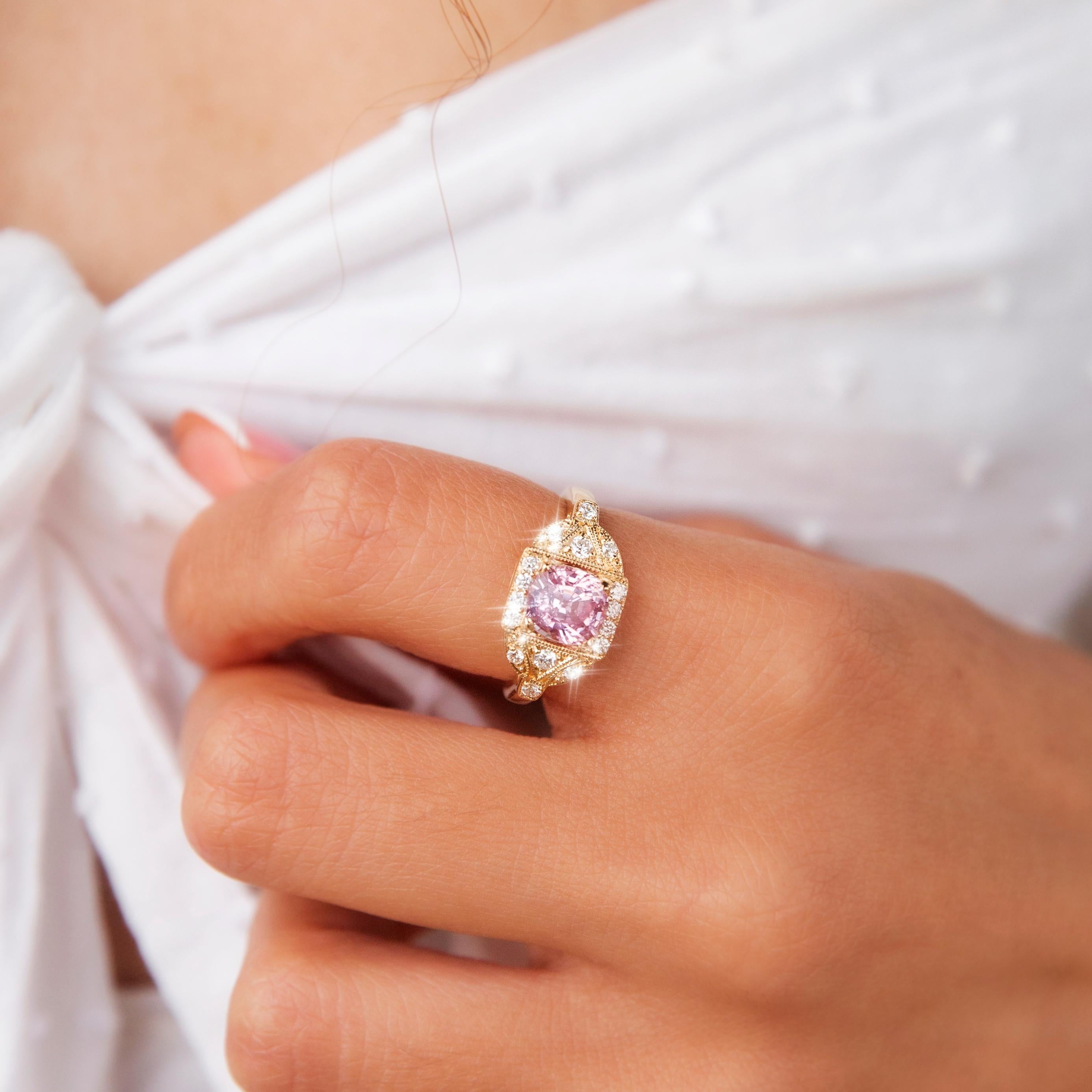 Forged in 18 carat yellow gold, this opulent contemporary cluster ring features an enchanting round cut light pink spinel in an elaborate diamond-encrusted milgrain bead setting. She has been named The Mariah Ring. Her classic design makes her a