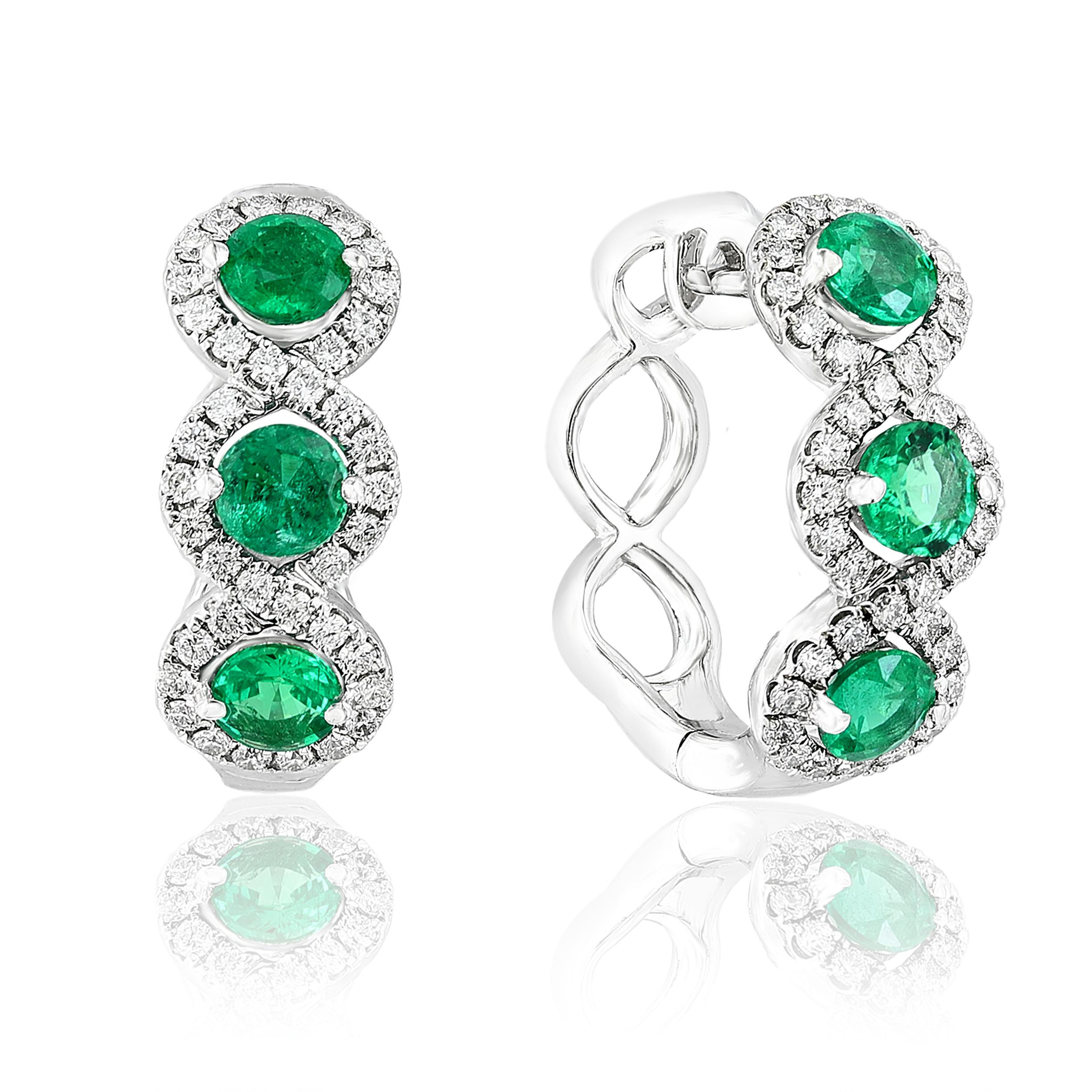 A chic and fashionable pair of hoop earrings showcasing brilliant-cut 6-round emeralds weigh 1.72 carats in total, set in 18k white gold.  76 Round diamonds surrounding the emaralds weigh 0.76 carats total. A beautiful piece of jewelry.

Style is