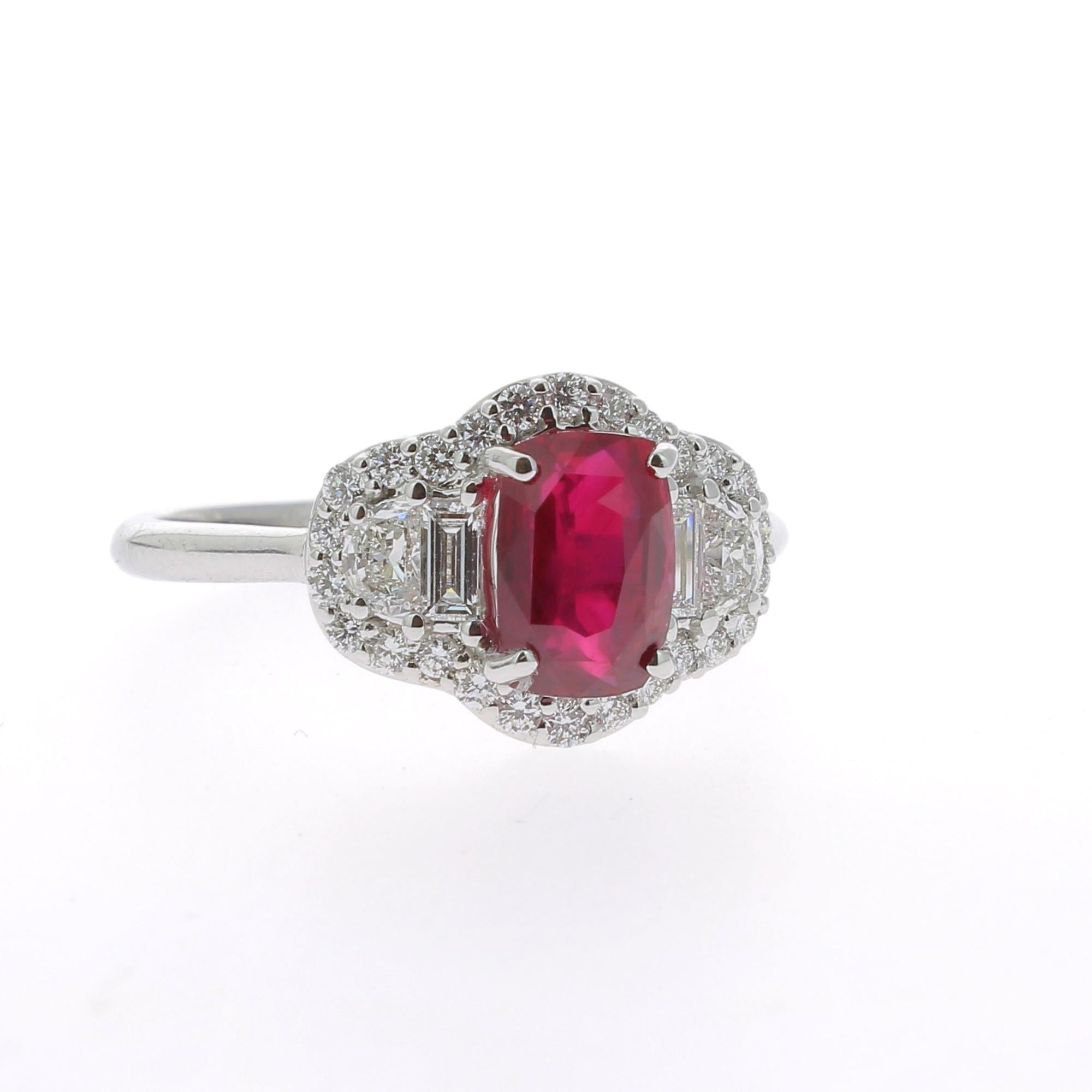 An amazing Ruby Ring flanked on each side by a single Half Moon Diamond, a single Baguette Diamond and surround with round Diamond.
The total weight of the Ruby is 1.72 Carats, the gemstone is certified. 
The Diamond weight is 0.58 Carats.
The Ruby