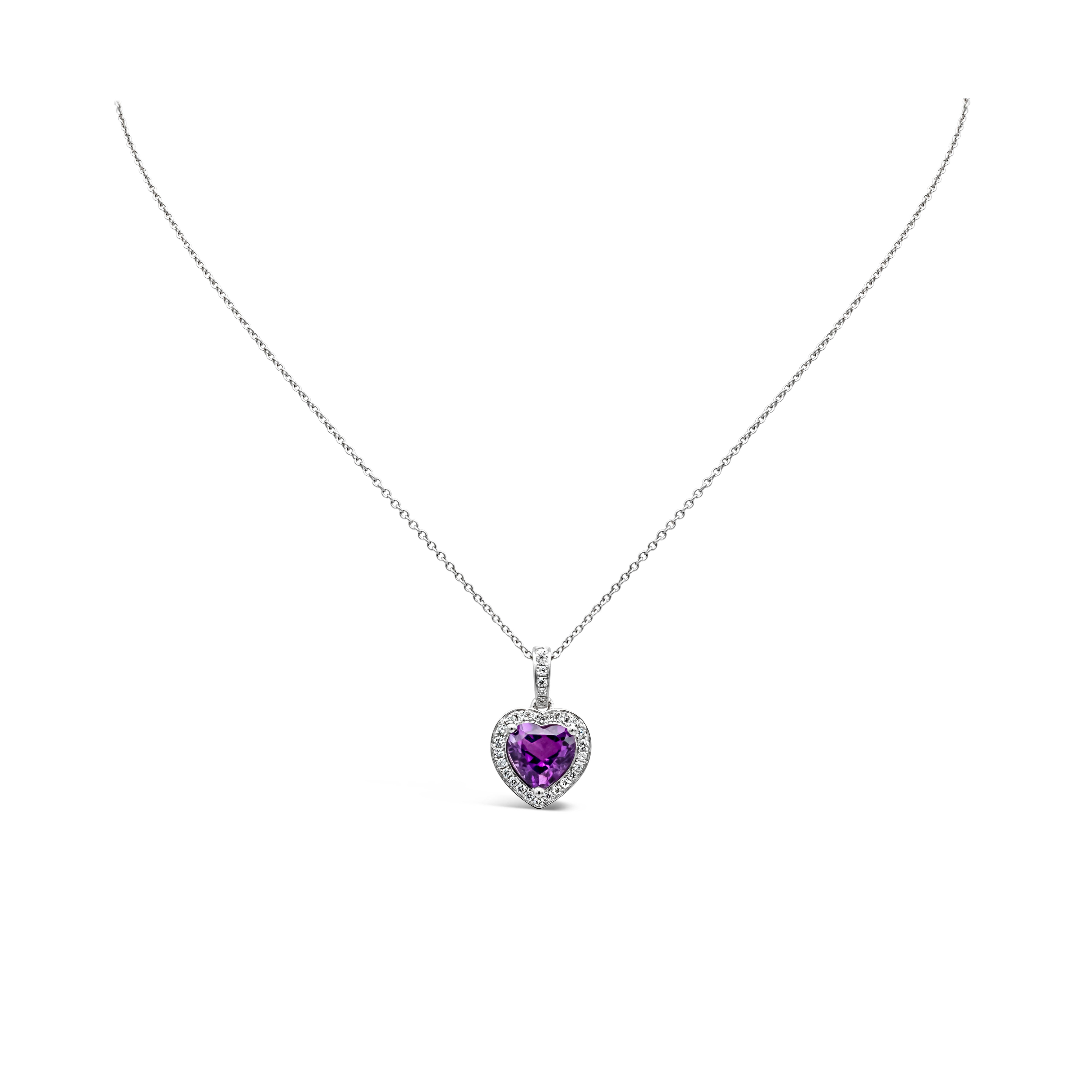 A beautiful and versatile pendant necklace showcasing a vibrant 1.72 carats heart shape purple amethyst in the center, set in a classic three prong setting. Surrounded by a single row round brilliant diamonds and hanging by a diamond encrusted bail