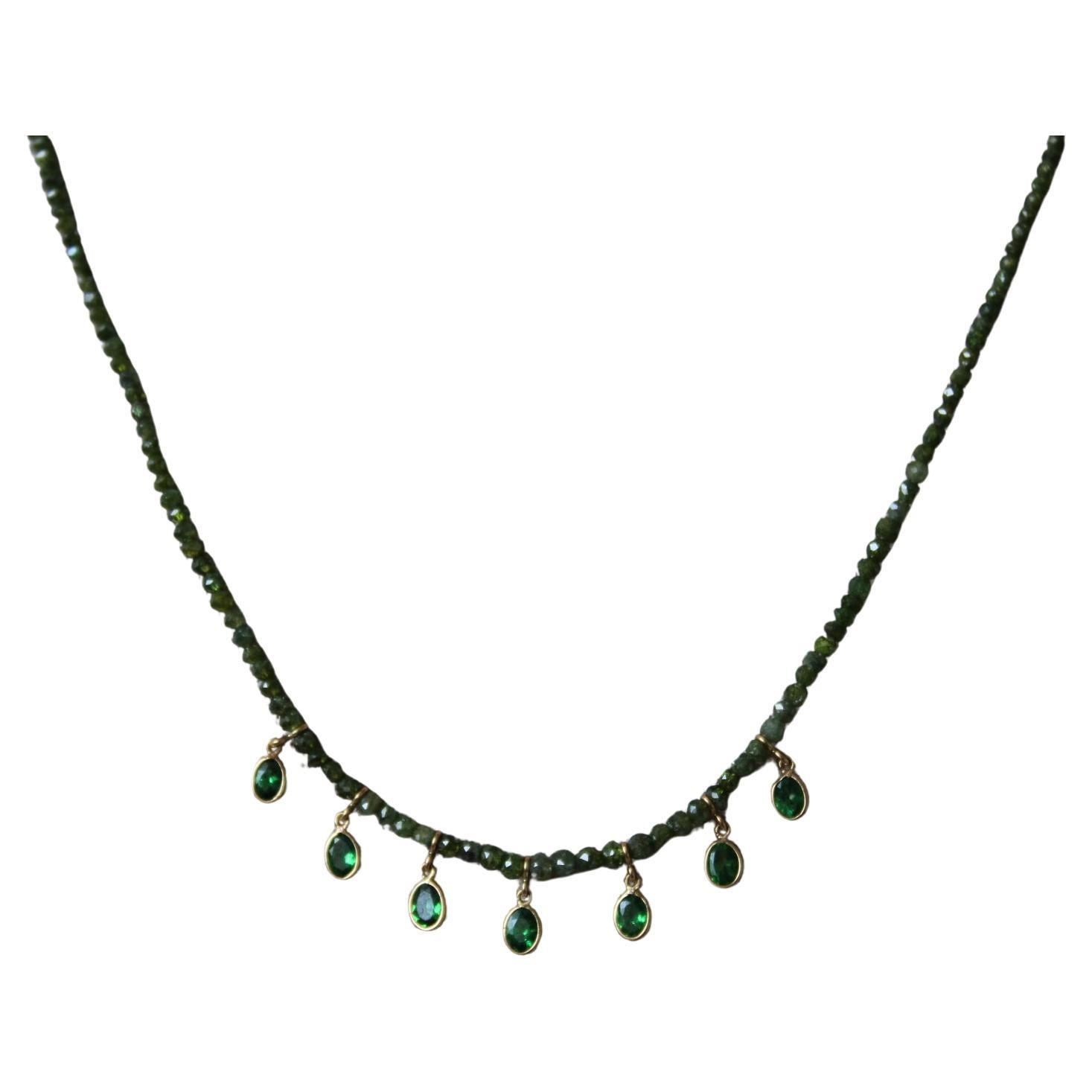 This stunning diamond bead strand necklace is truly unique. Comprised of 17.22 carats of diamond beads and 18K gold, this chain is also adorned by 1.09 carats of seven hunter green Tsavorite Pears. This diamond beads create sparkle with every move