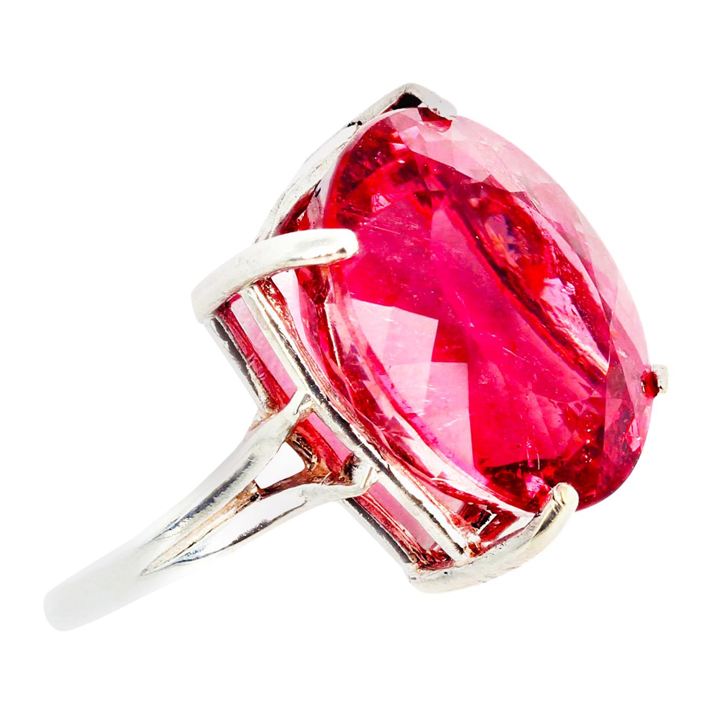 There are no eye visible inclusions in this glittering brilliant 17.22 carat pink Tourmaline set in this lovely simple sterling silver ring size 6.5 sizable FOR FREE.  This gorgeous PINK gemstone is 17 mm x 15 mm approximately and photographs darker