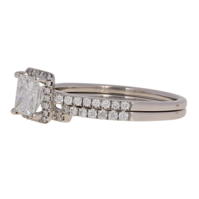 Give your princess the bridal set of her dreams! Created by Sylvie in 14k white gold, this halo engagement ring and matching enhancer-style wedding band sparkle with a brilliant collection of natural diamonds.    

These rings are a size 9, but they