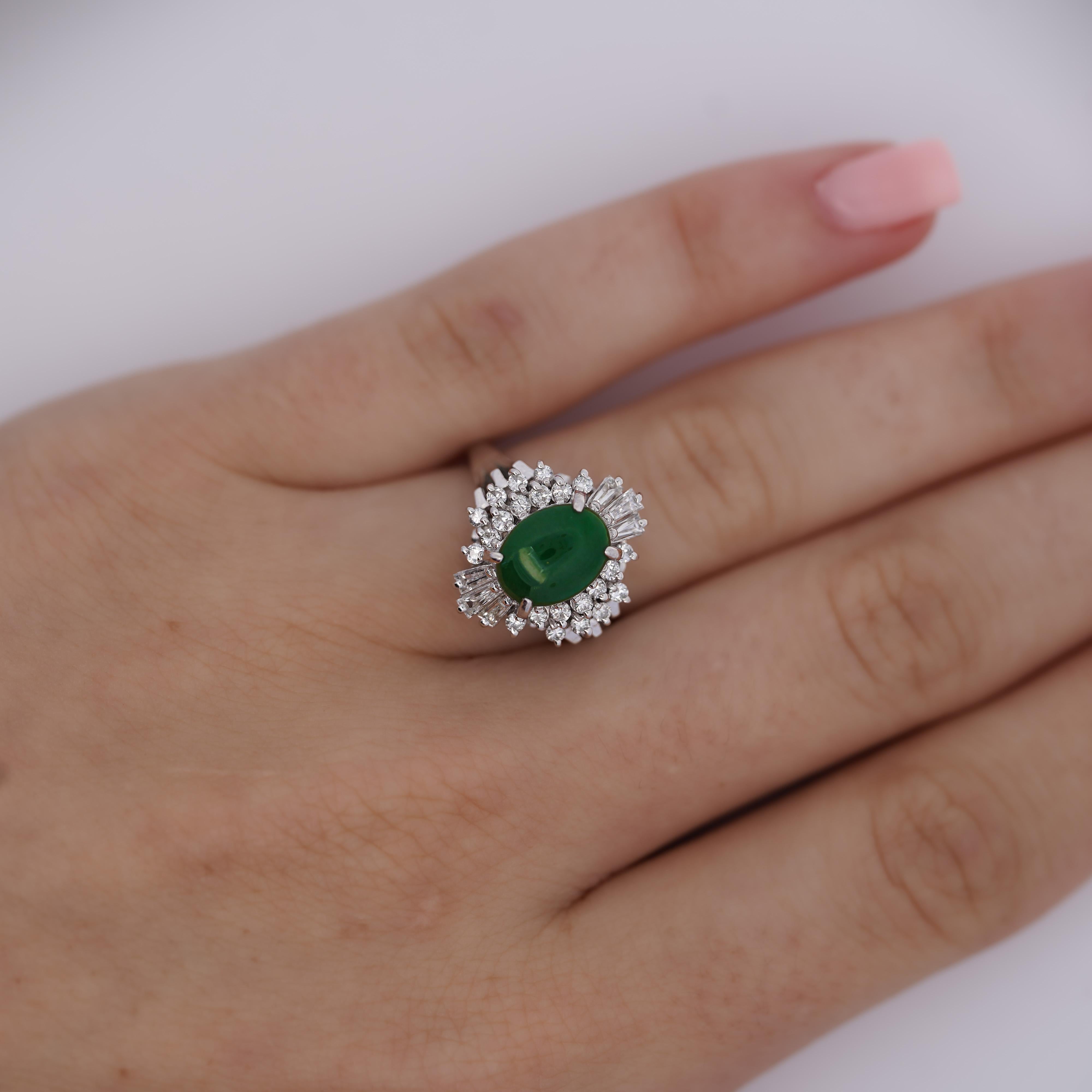 This platinum cathedral set ring presents stunning filigree along the bridge. A luscious natural green jade stone rests at the rings head. Certified by The Hong Kong jade and Stone lab this glorious jade boasts 1.73 carats and an oval cut. Perfectly