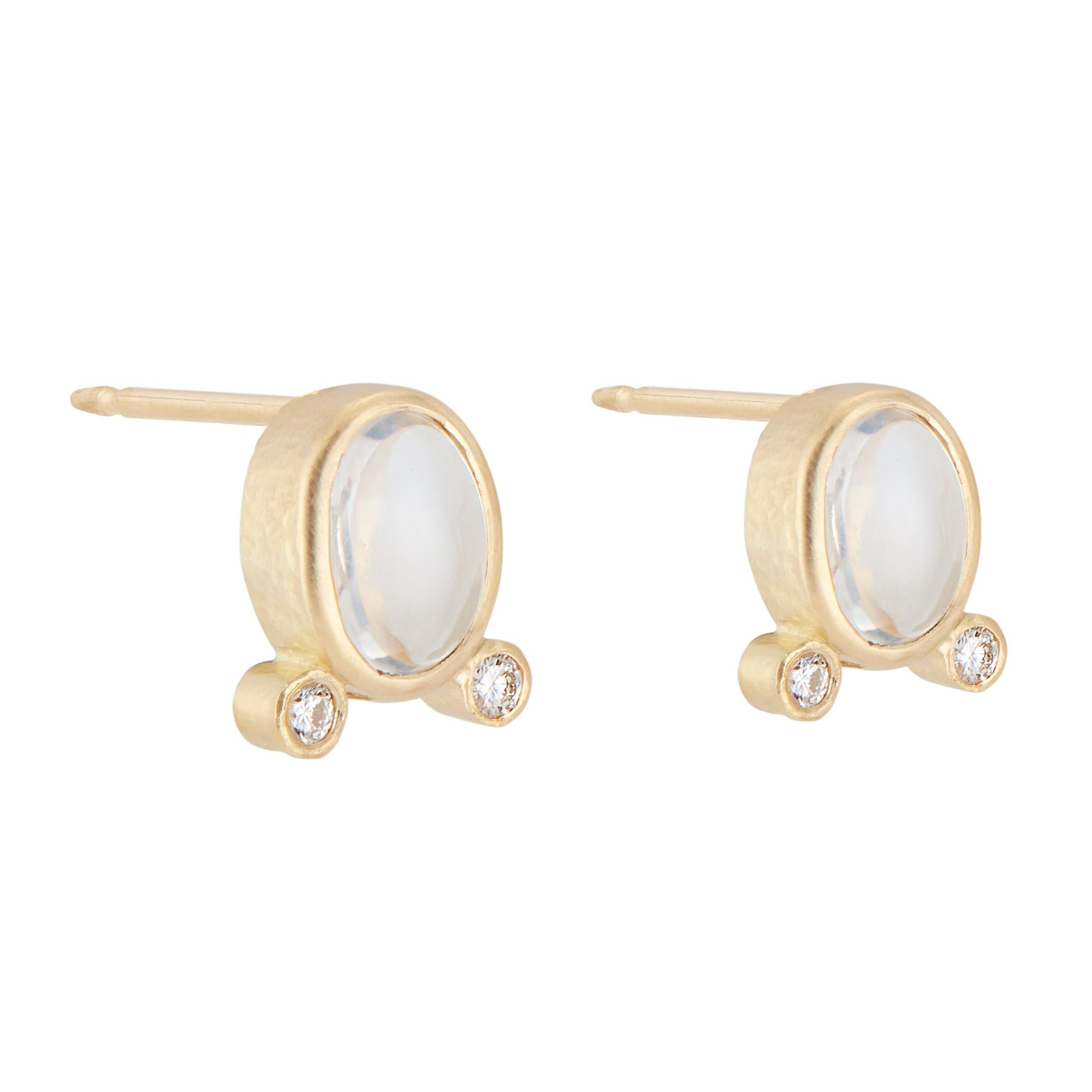 Moonstone and diamond earrings. 2 oval bezel set moonstones, each with 2 round brilliant cut accent diamonds, in 18k yellow gold textured settings.  

2 oval bluish white cabochon moonstones, approx. 1.73cts
4 round brilliant cut diamonds, G VS