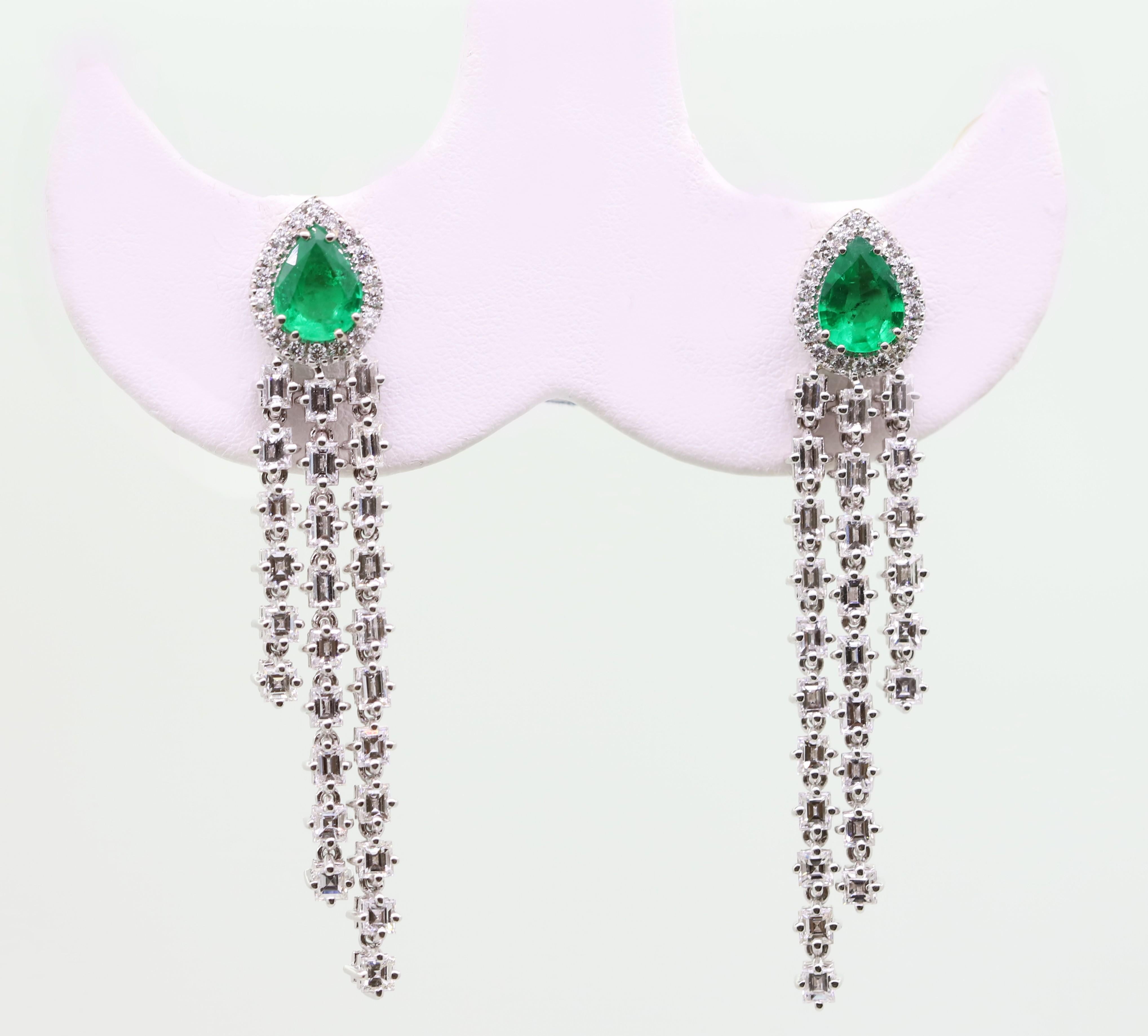 Elegant and refined Dangle Earrings featuring 2 Pear Shape Vivid Green Emerald for 1.72 Carat Total, 
framed by Round White Diamonds.
Three dangling lines of White Baguette-cut Diamonds for 4.83 Carat Total give these Earrings a Feminine touch.
The