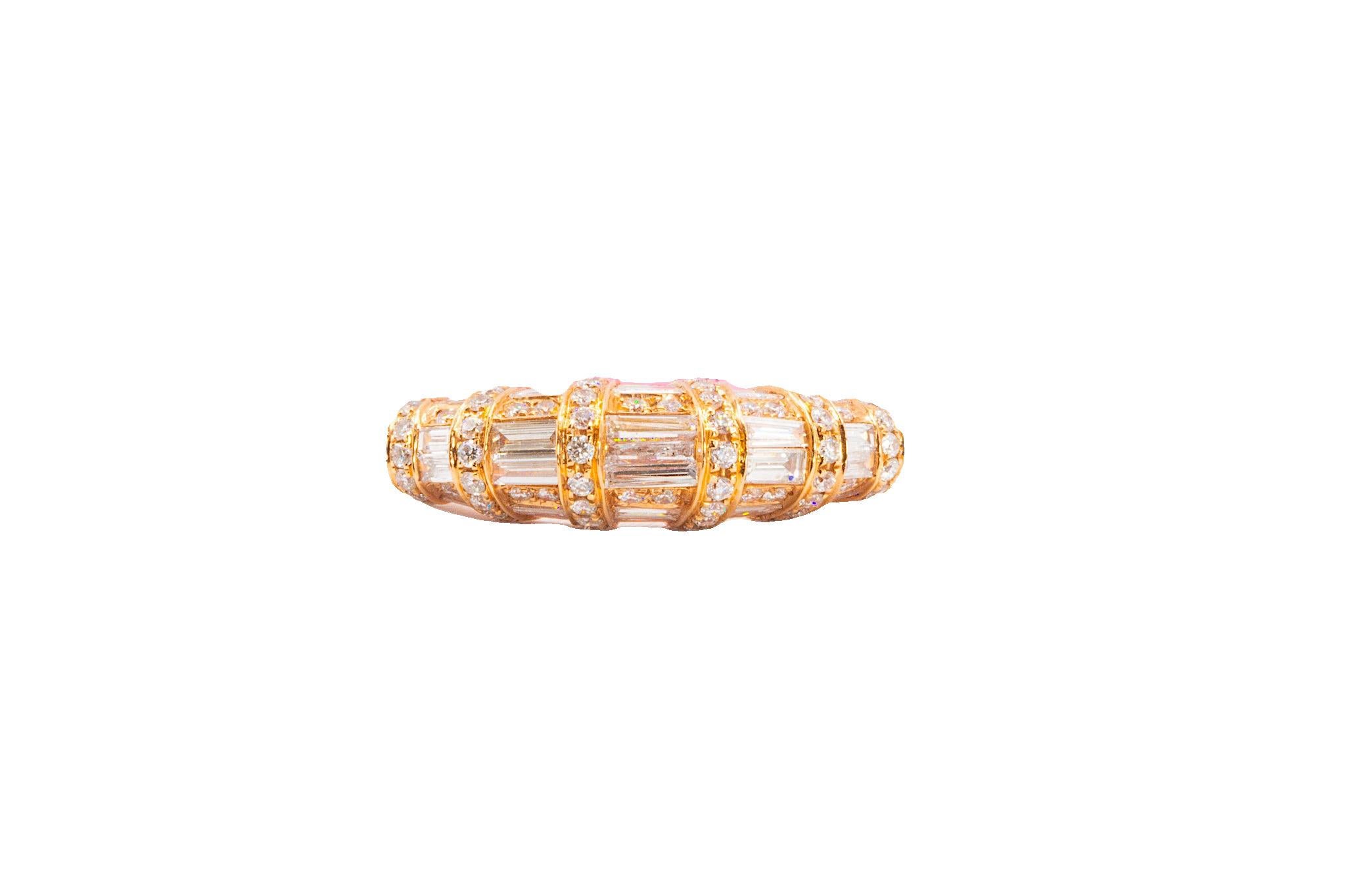 This architectural diamond band consists of both round brilliant cut and baguette cut natural diamonds. The 31 baguette cuts, totaling 0.98 ct. together (approx. 0.04-0.11 ct. each), are graduated in size and have a color of G and clarity of VS1.
