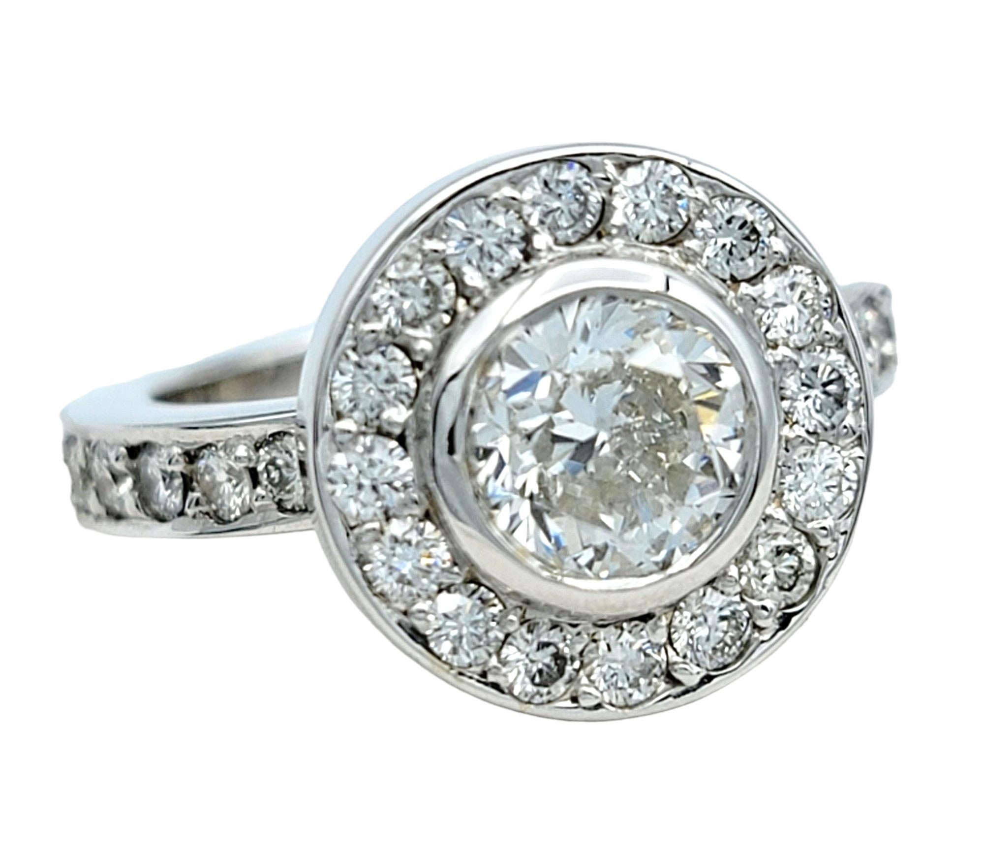Ring Size: 4.5

This stunning round diamond engagement ring is beautifully set in 18 karat white gold. The centerpiece of this exquisite ring is a .79 carat round brilliant diamond (H / VS2), surrounded by a dazzling halo of smaller diamonds that
