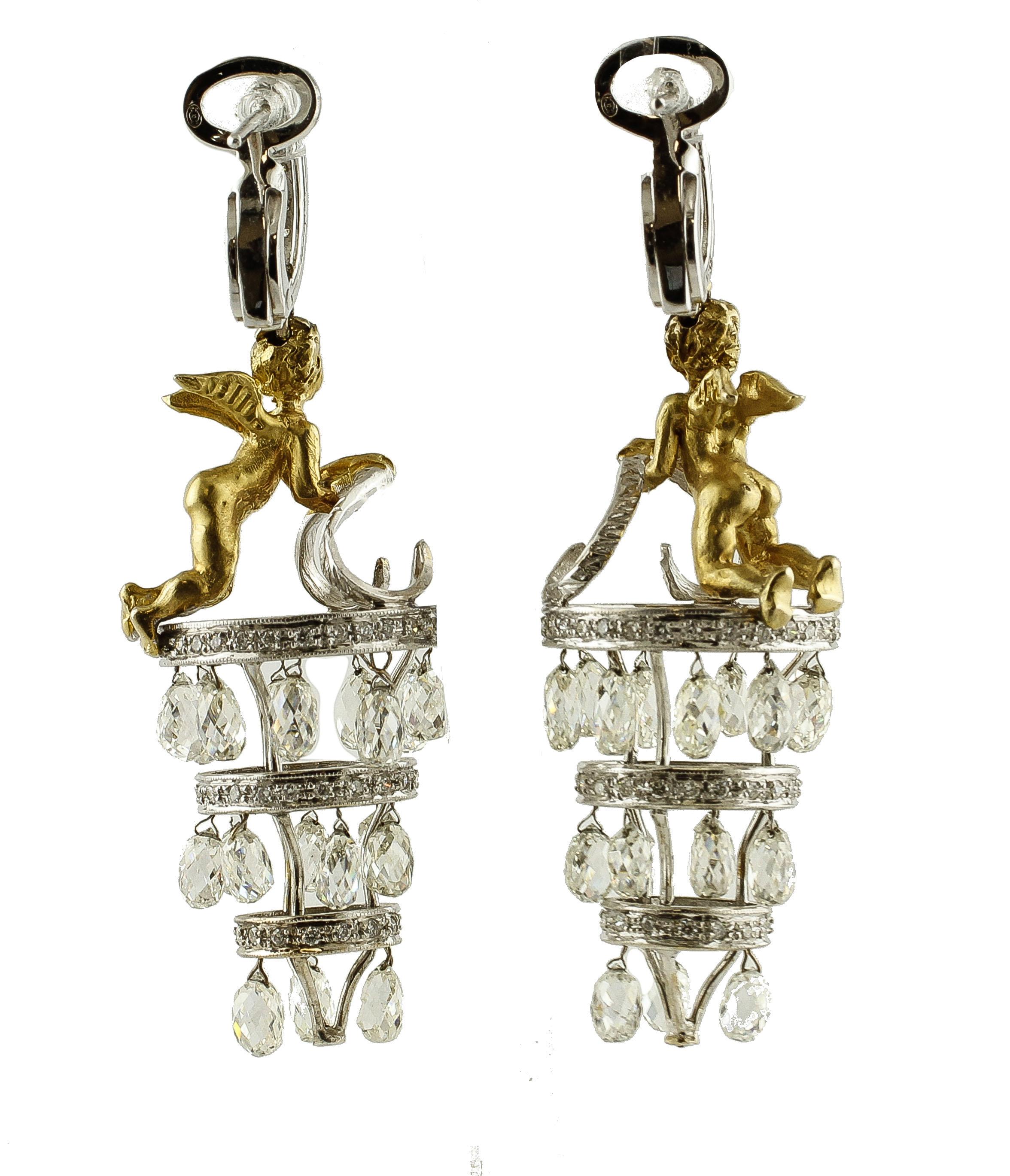 Astonishing pair of dangle earrings in 18k white and yellow gold structure. The earrings feature an angel realized in yellow gold, on a cylindrical structure realized with 3 white gold circles of different sizes studded with diamonds. Below each