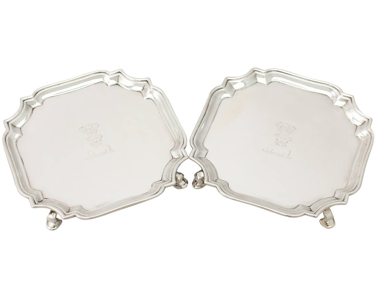 A fine and impressive pair of antique Georgian English sterling silver waiters, an addition to our silver tray, salver and platter collection.
These fine antique George II sterling silver waiters have a Classic plain square form with shaped