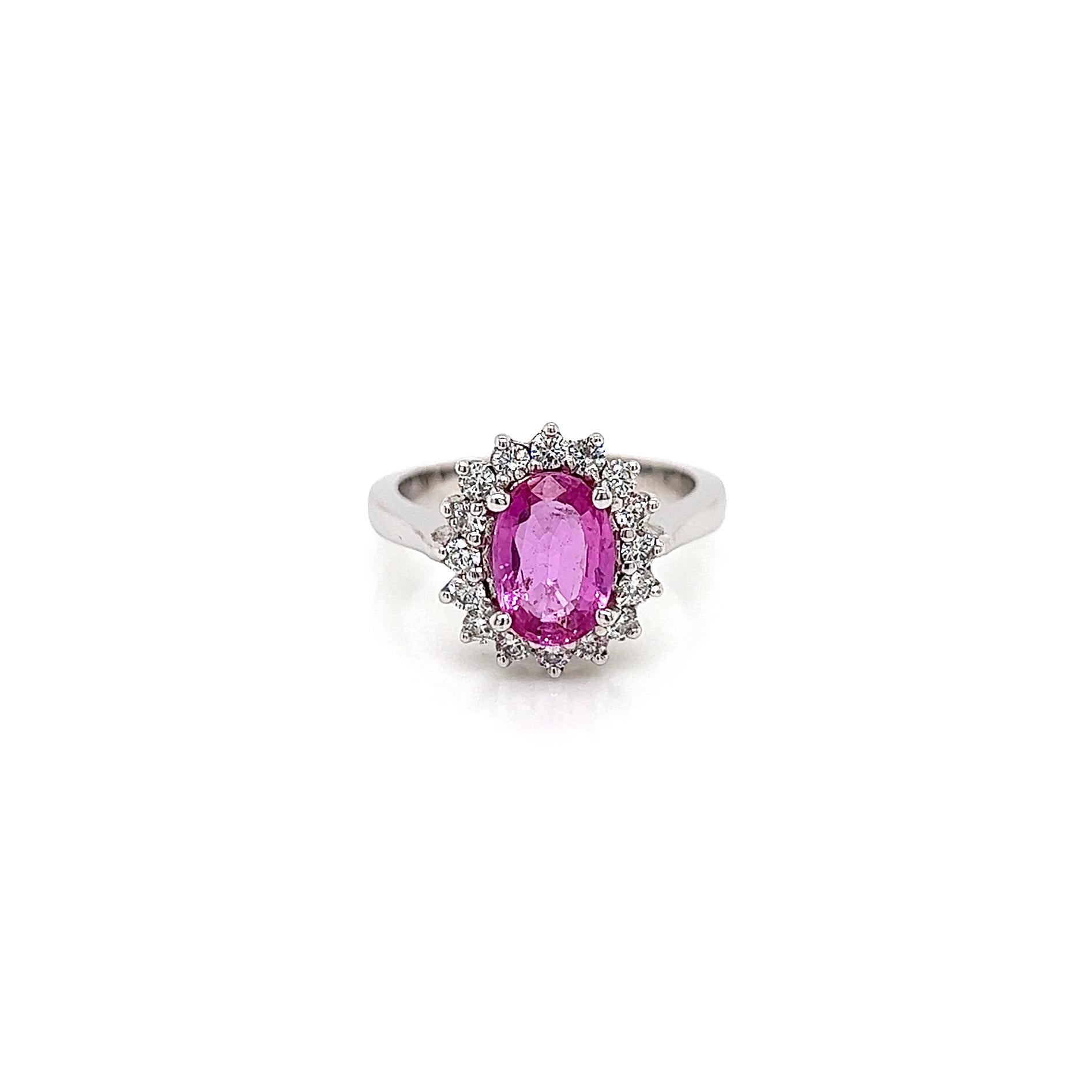 2.16 Total Carat Pink Sapphire Diamond Halo Ladies Ring

-Metal Type: 18K White Gold 
-1.73 Carat Oval Cut Pink Sapphire  
-0.43 Carat Round Side Natural Diamonds, F-G Color, VS-SI Clarity
-Size 6.5

Made in New York City.
