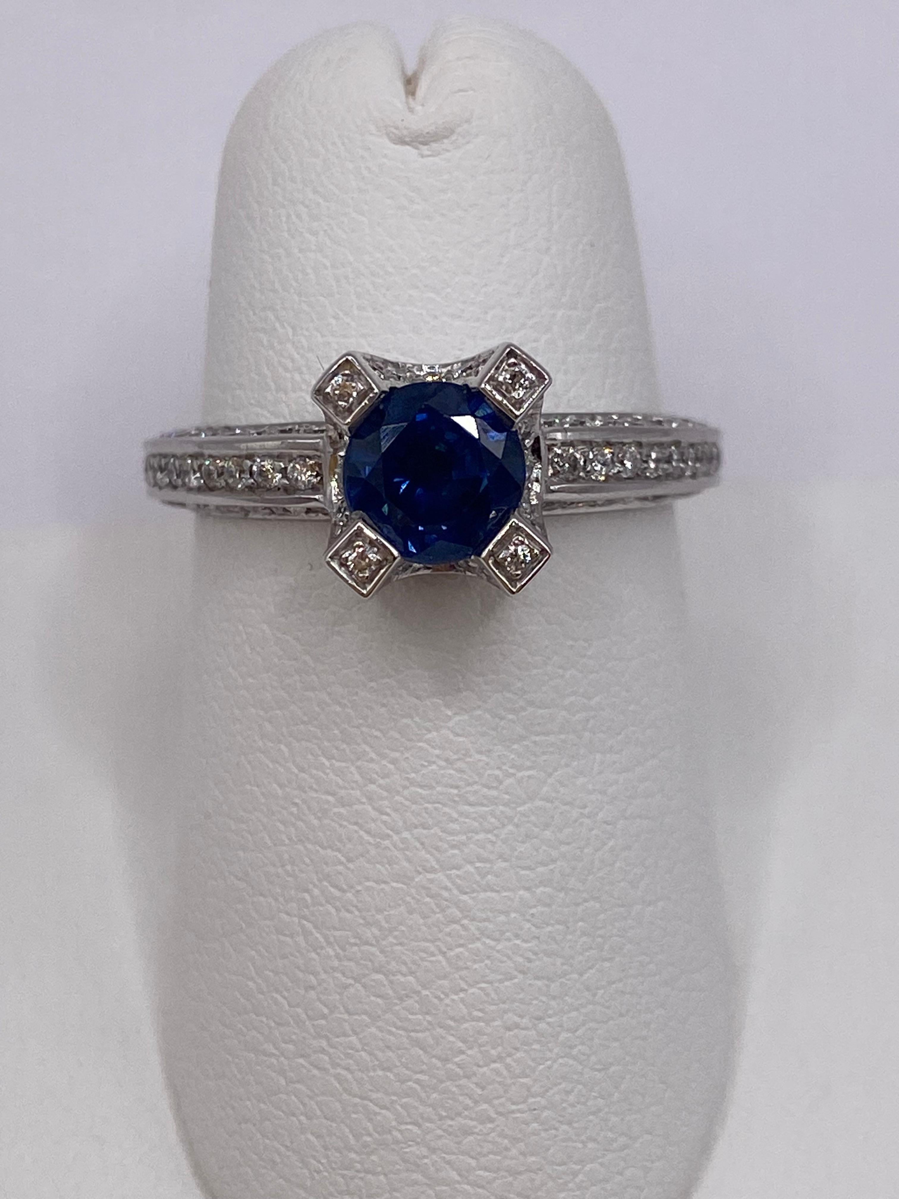 Metal: 14KT White Gold
Ring Size: 6.75
(Ring is size 6.75, but sizable upon request)

Number of Round Sapphires: 1
Carat Weight: 1.10ctw
Stone Size: 5.9mm

Number of Round Diamonds: 96
Carat Weight: 0.63ctw